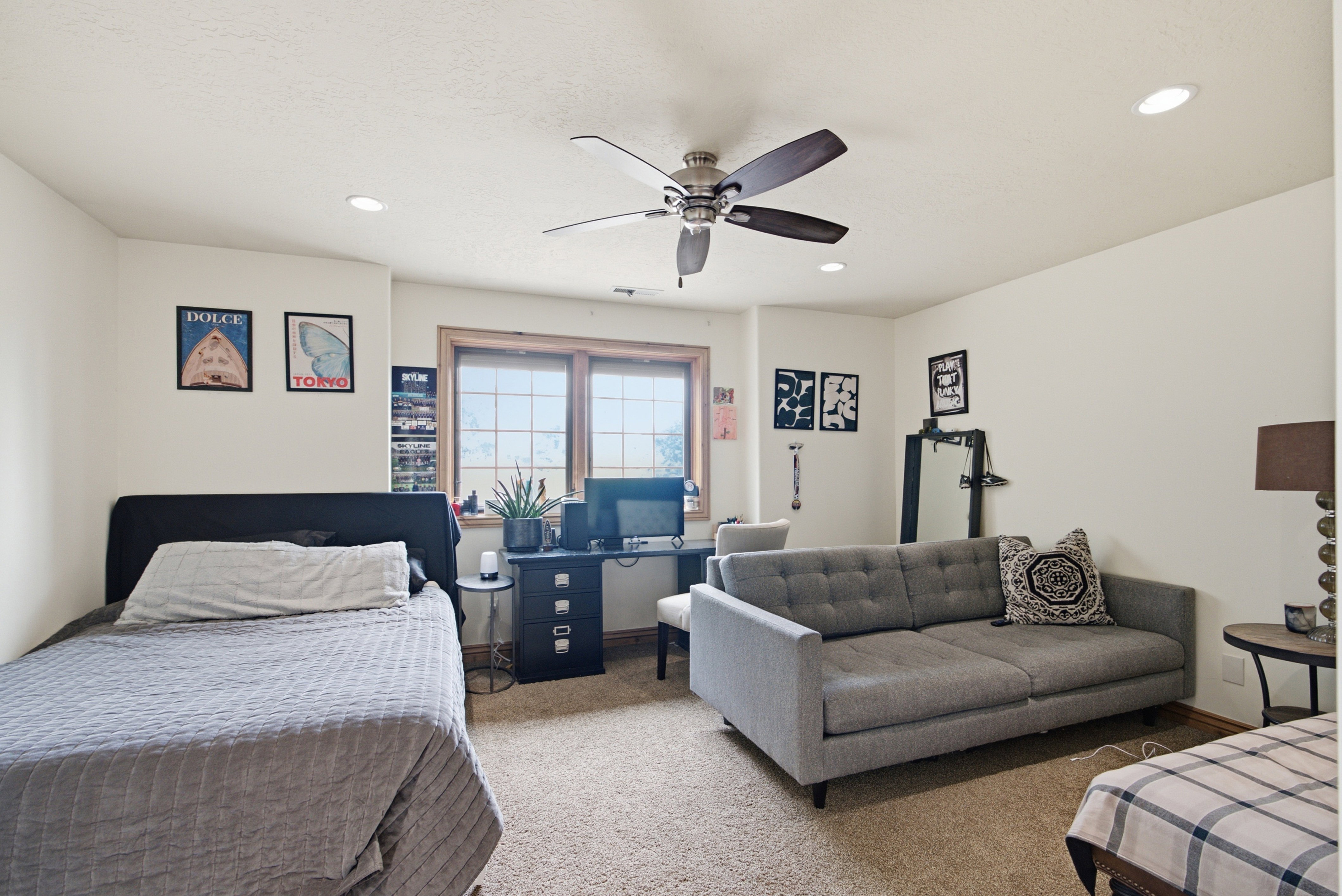Neutral wall tones with recessed lighting and a ceiling fan