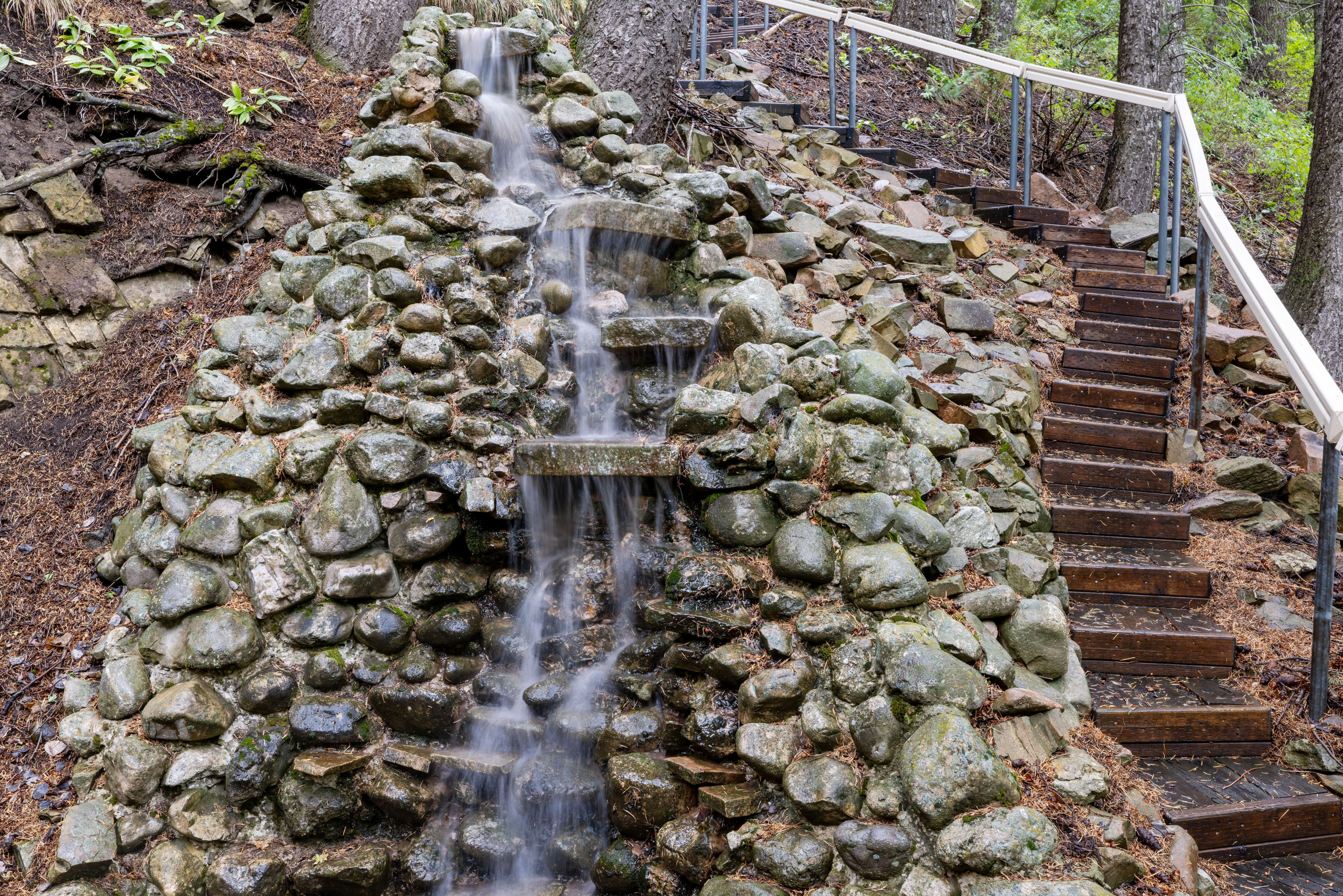 Stone waterfall with stairs that lead to Lovers Ln.