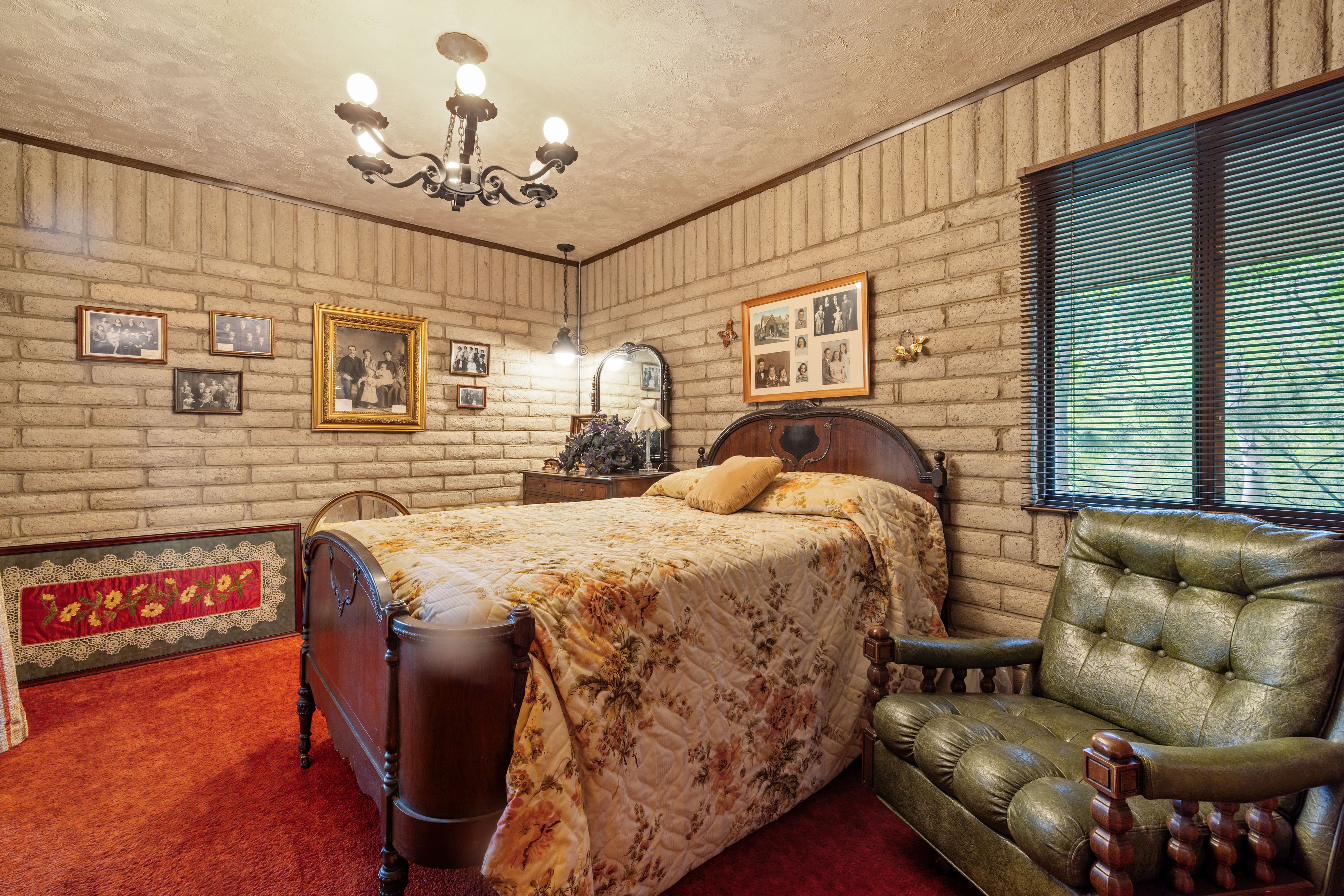 Main floor bedroom featuring brick walls and a dark wood trim accent