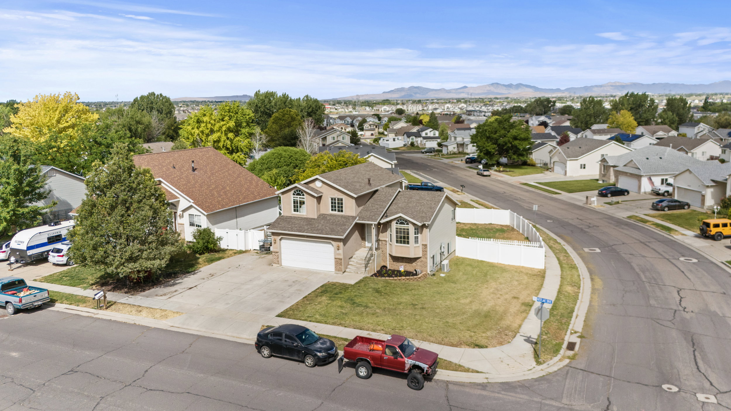 Two-story residence with an integrated garage, bay window, and a light-toned exterior