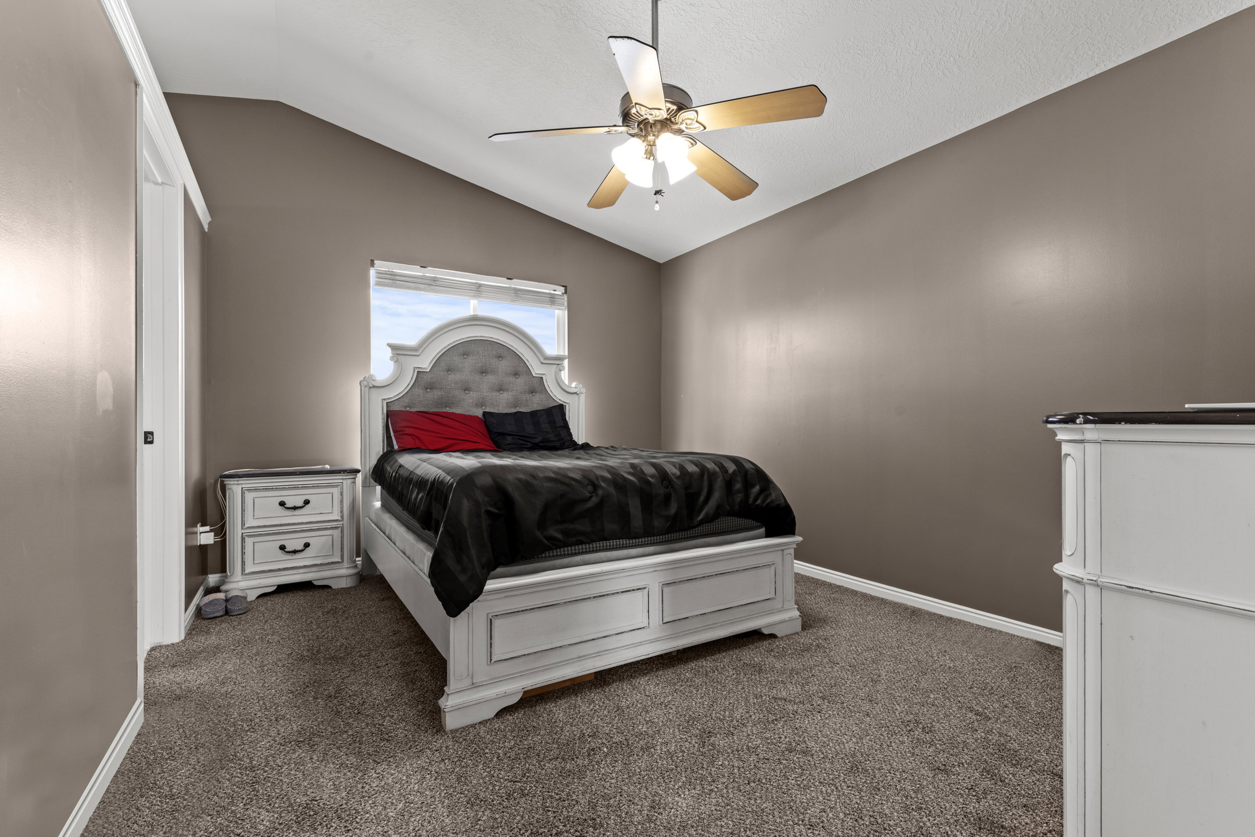 Room featuring vaulted ceilings and neutral wall tones