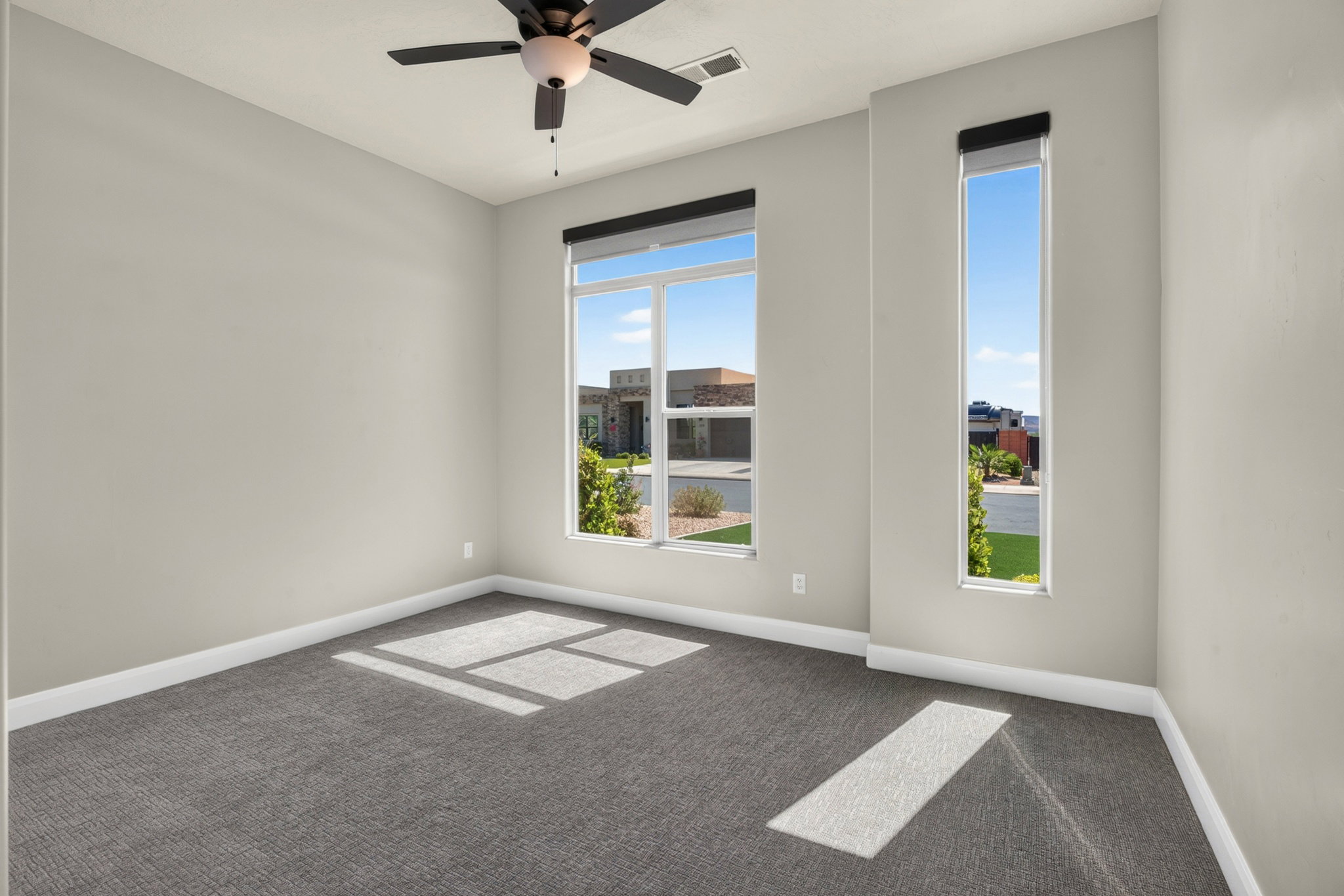 Room featuring an oversized picture window and a vertical accent window