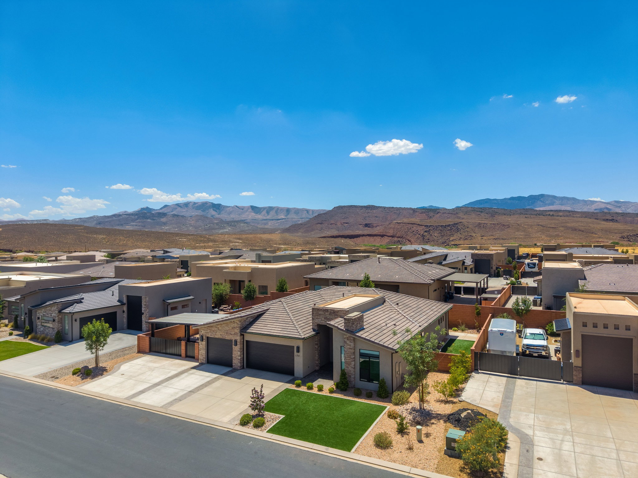 Contemporary single-story residence featuring a tile roof and a desert-inspired landscape