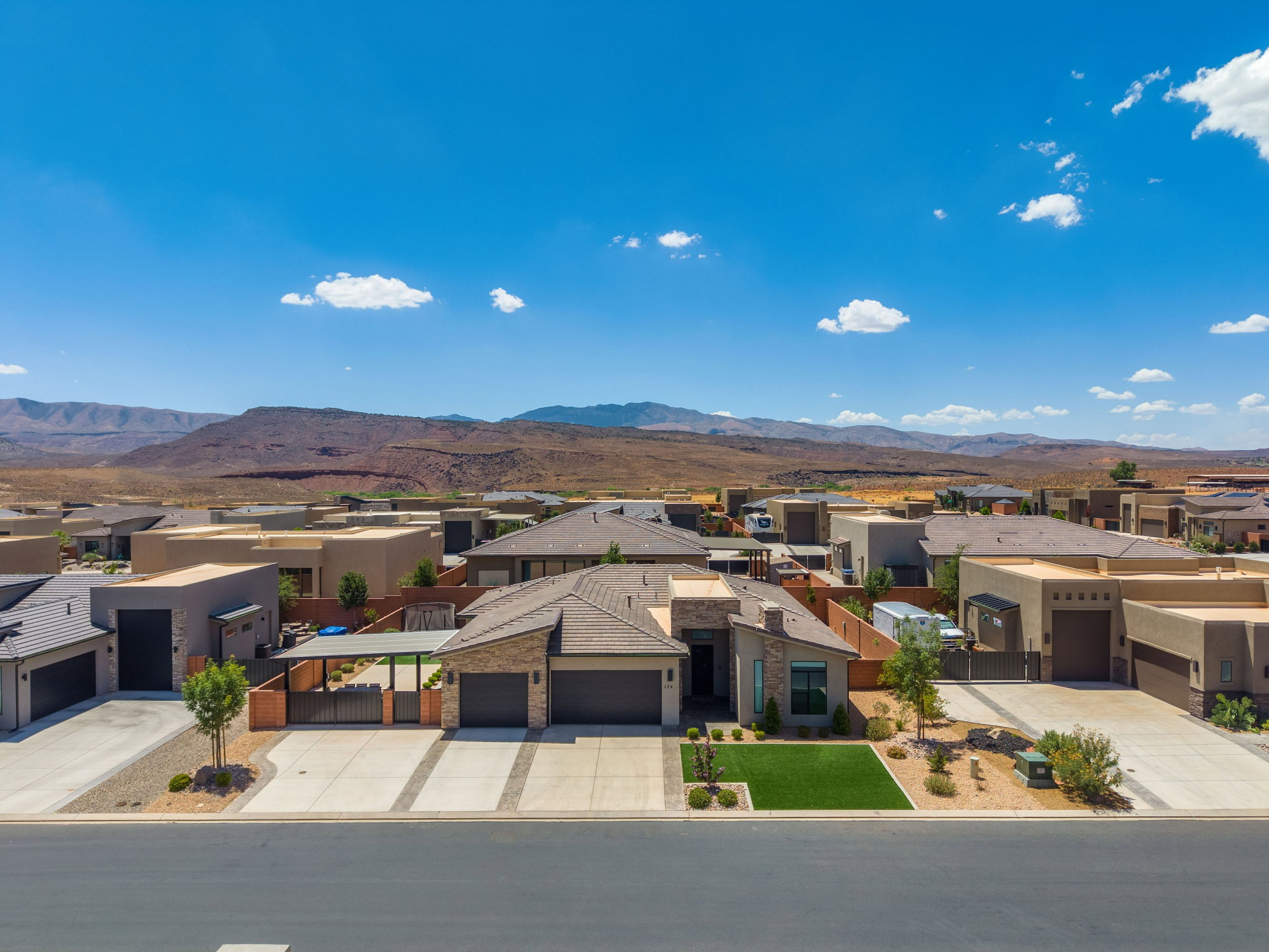 Contemporary residence featuring a low-slope roofline and a stone and stucco exterior