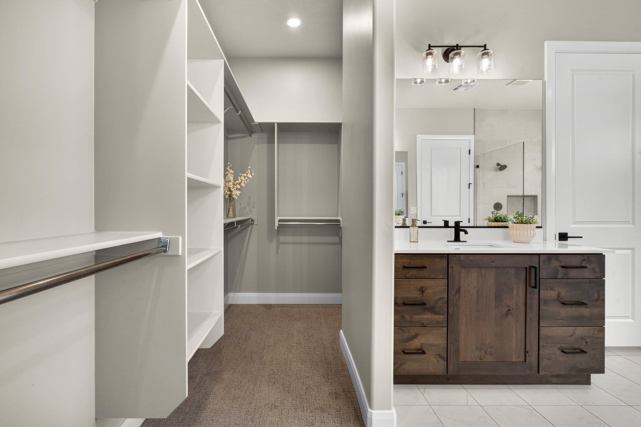 Spacious walk-in closet with extensive built-in shelving and hanging rods