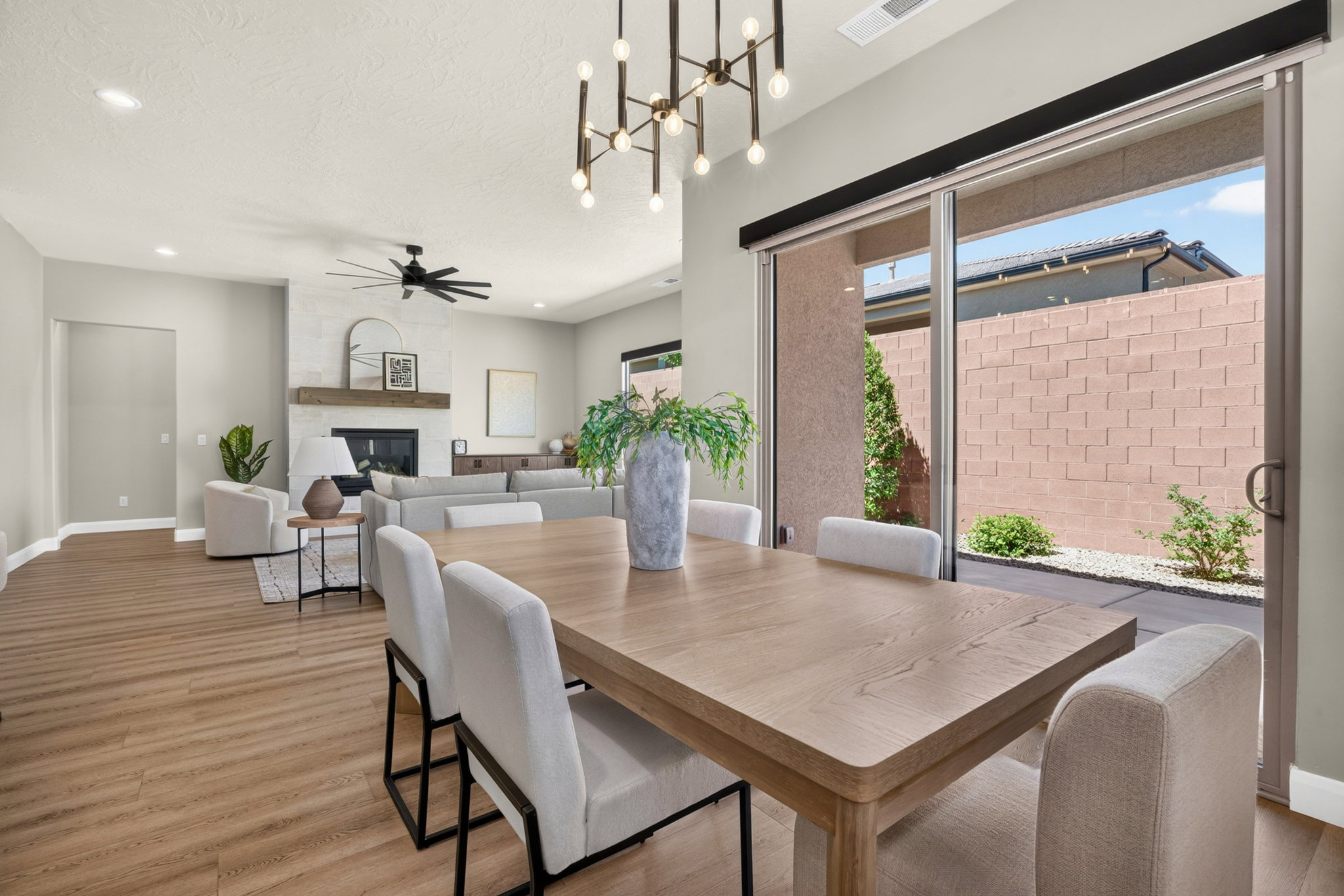 Open concept dining area featuring wood-finish flooring and a contemporary chandelier