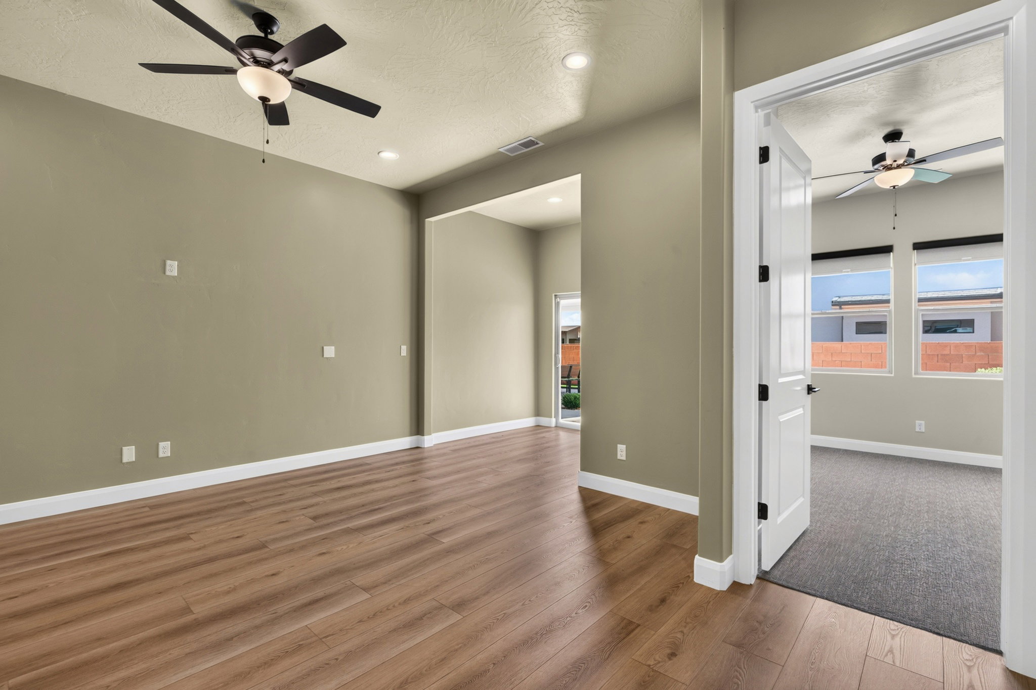 Spacious interior with wood-finish flooring, recessed lighting, and a ceiling fan