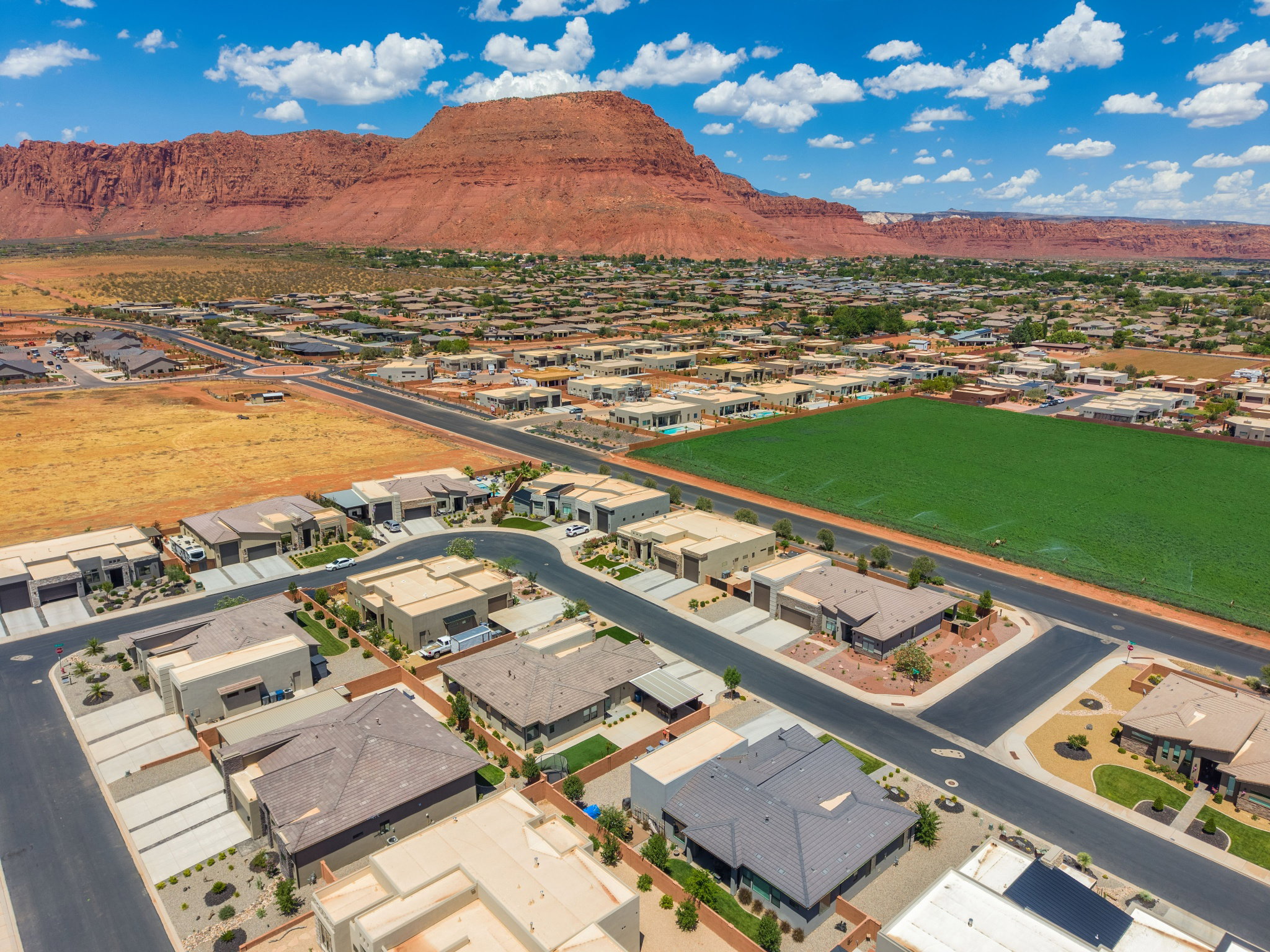 Aerial perspective showcasing residential properties with a mountainous backdrop