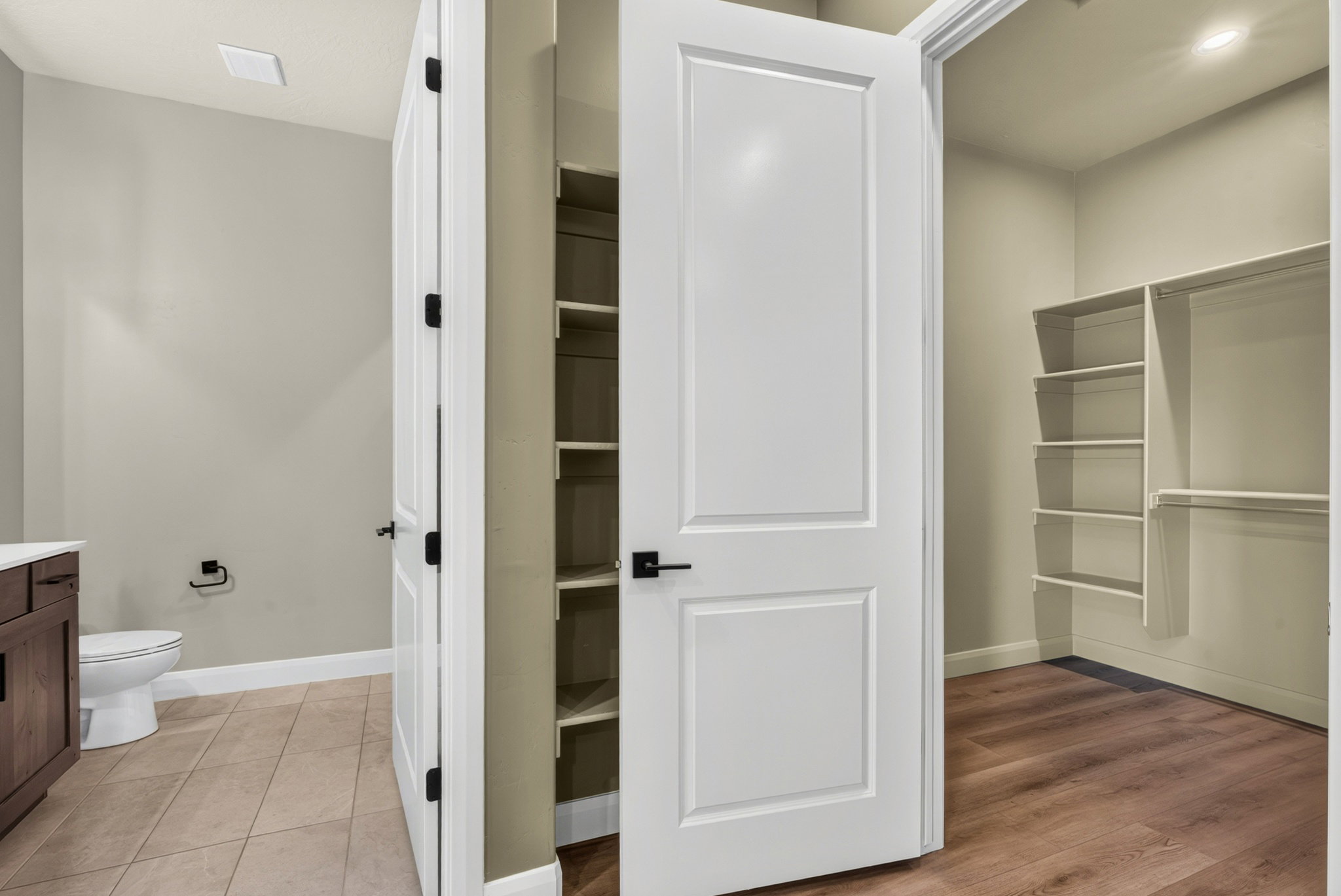 Walk-in closet featuring built-in shelving and hanging rods