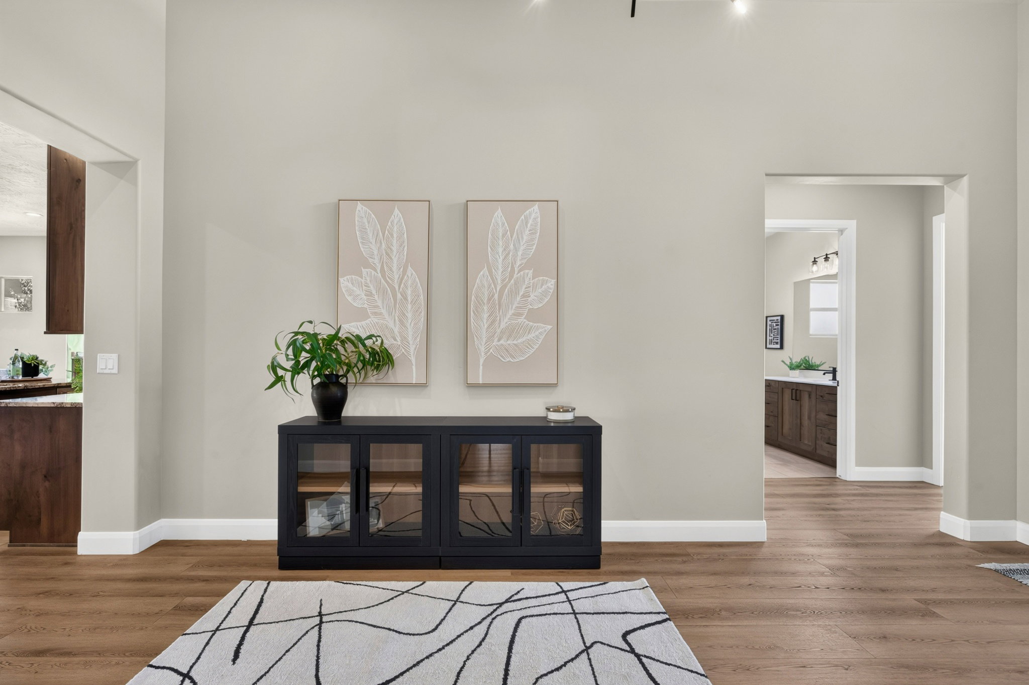 High ceilings, wood-finish flooring, and crisp white baseboards