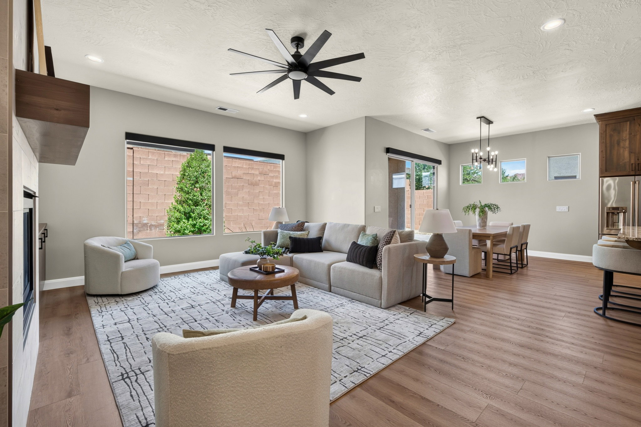 Open-concept living space featuring wood-finish flooring, recessed lighting, and a modern ceiling fan