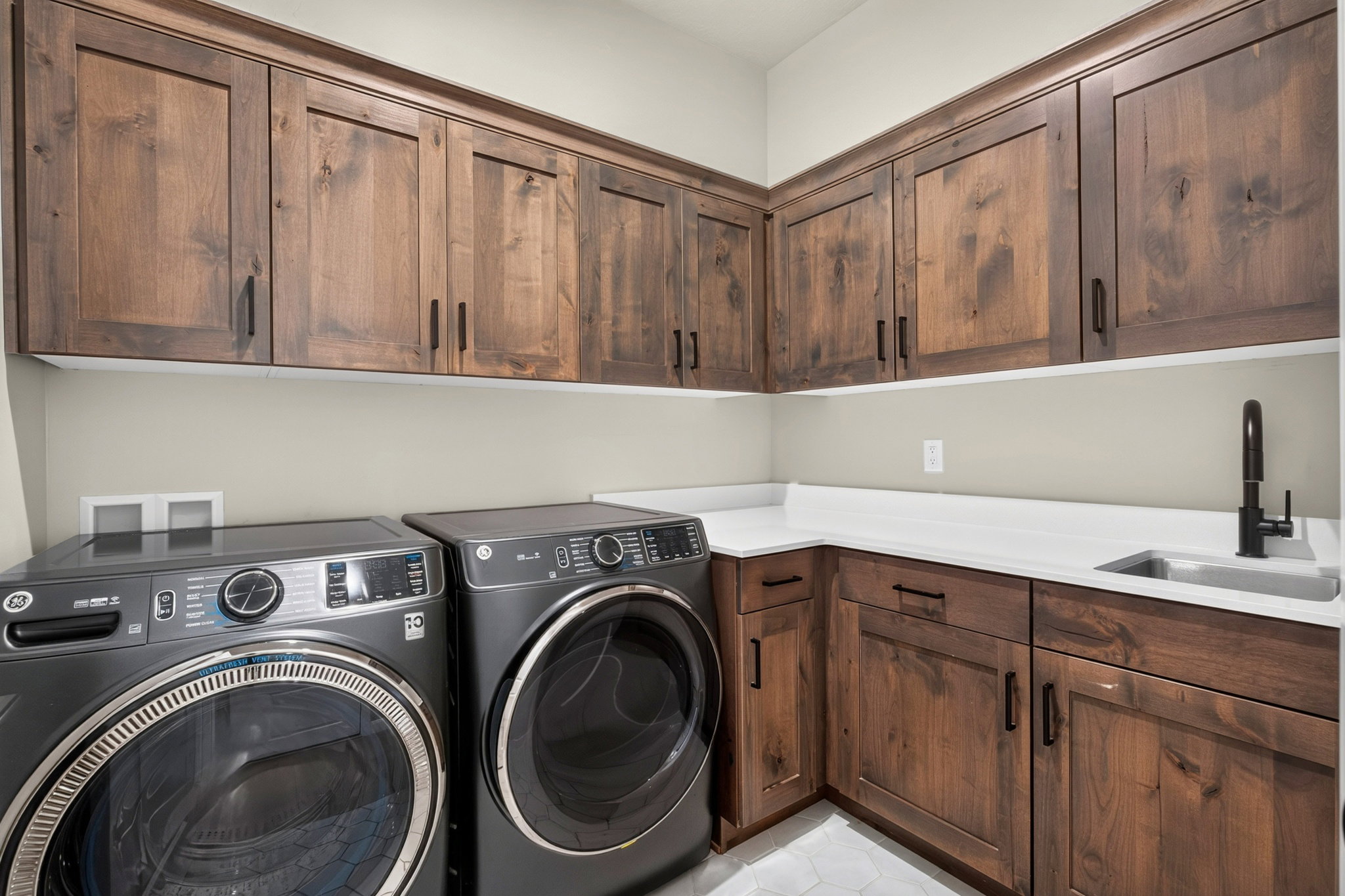 Custom wood-finish cabinetry with black hardware