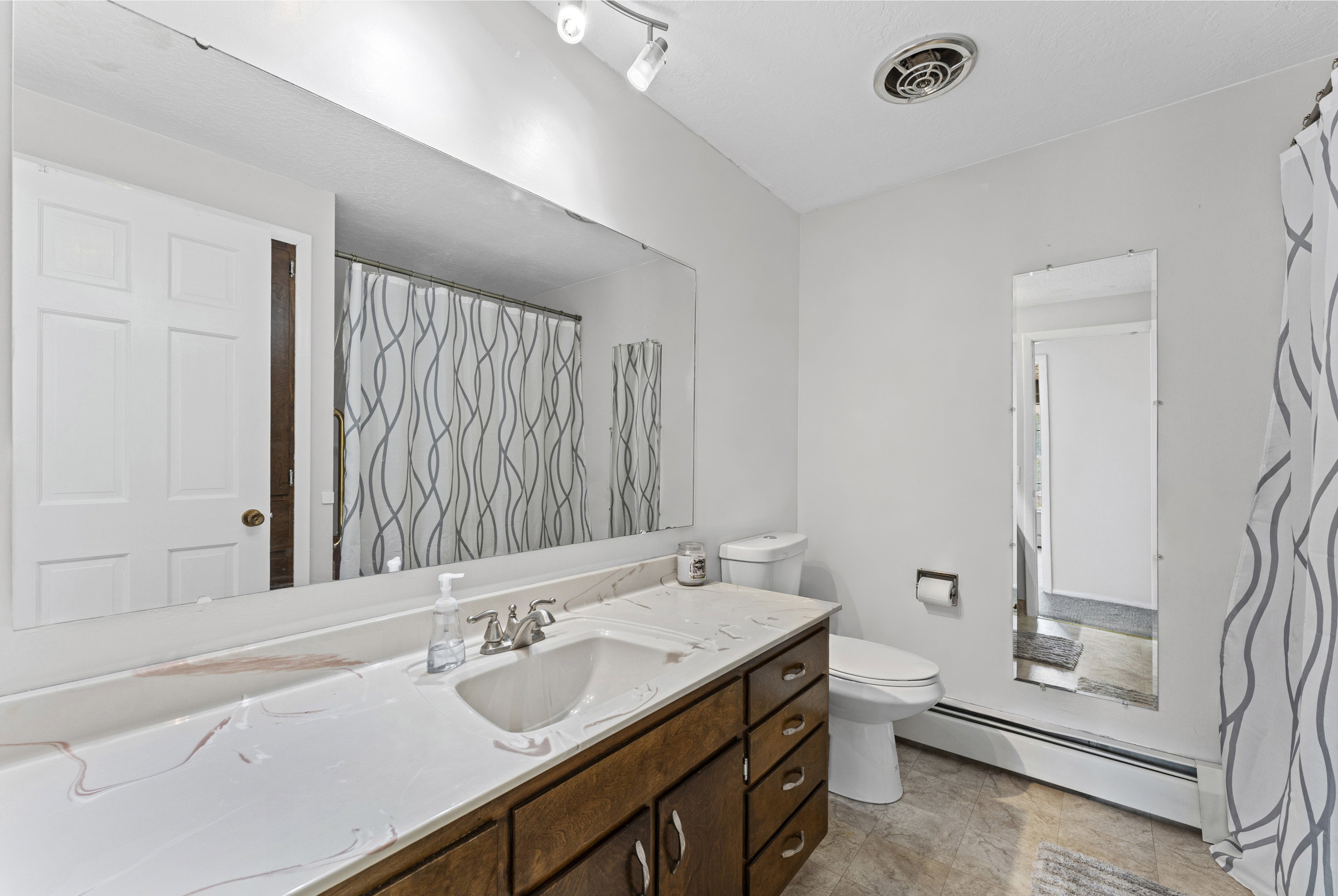 Full vanity with an integrated sink and wood-finish cabinetry