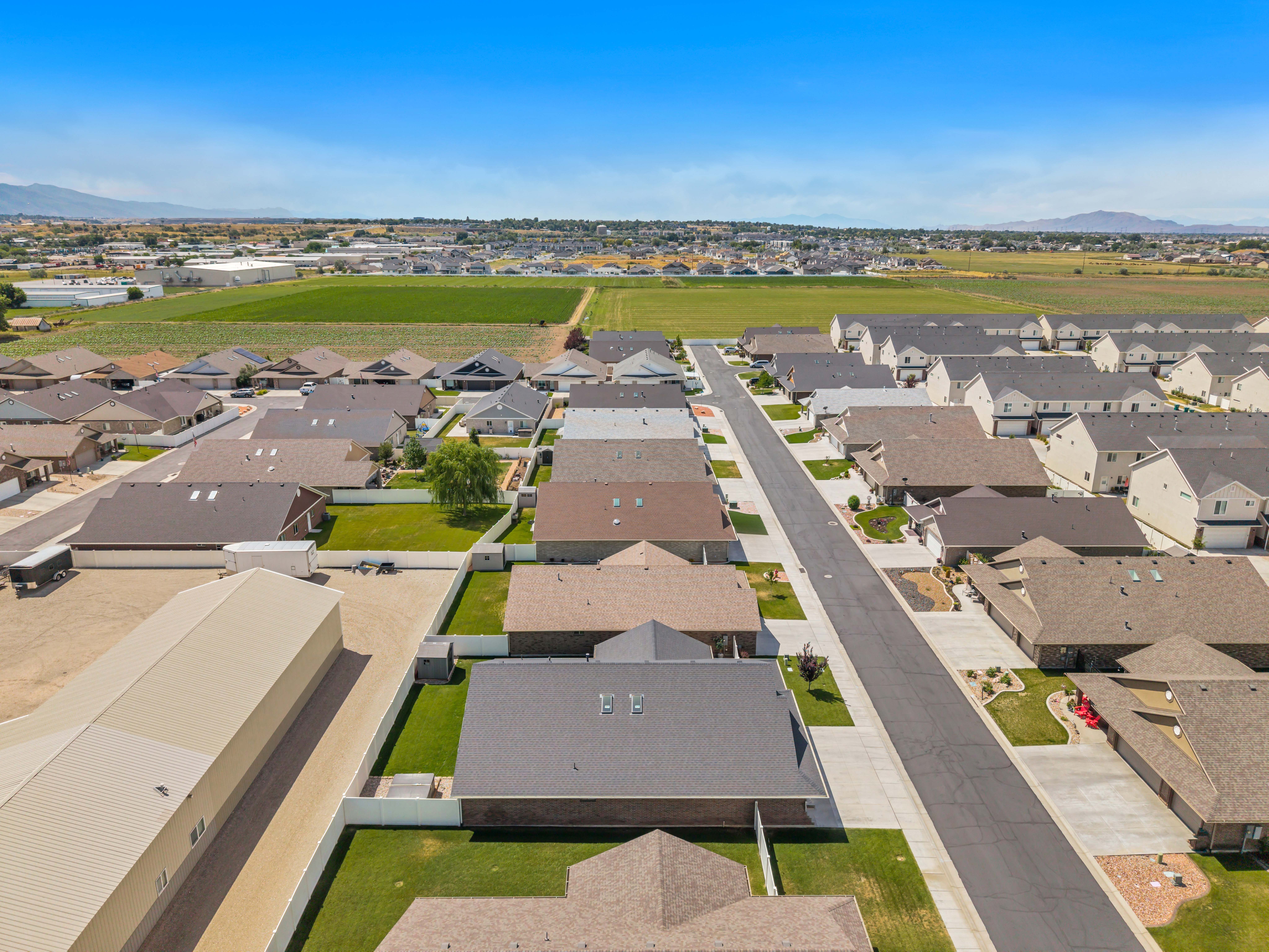 Aerial perspective showcasing a residential community with uniform roofing and landscaping