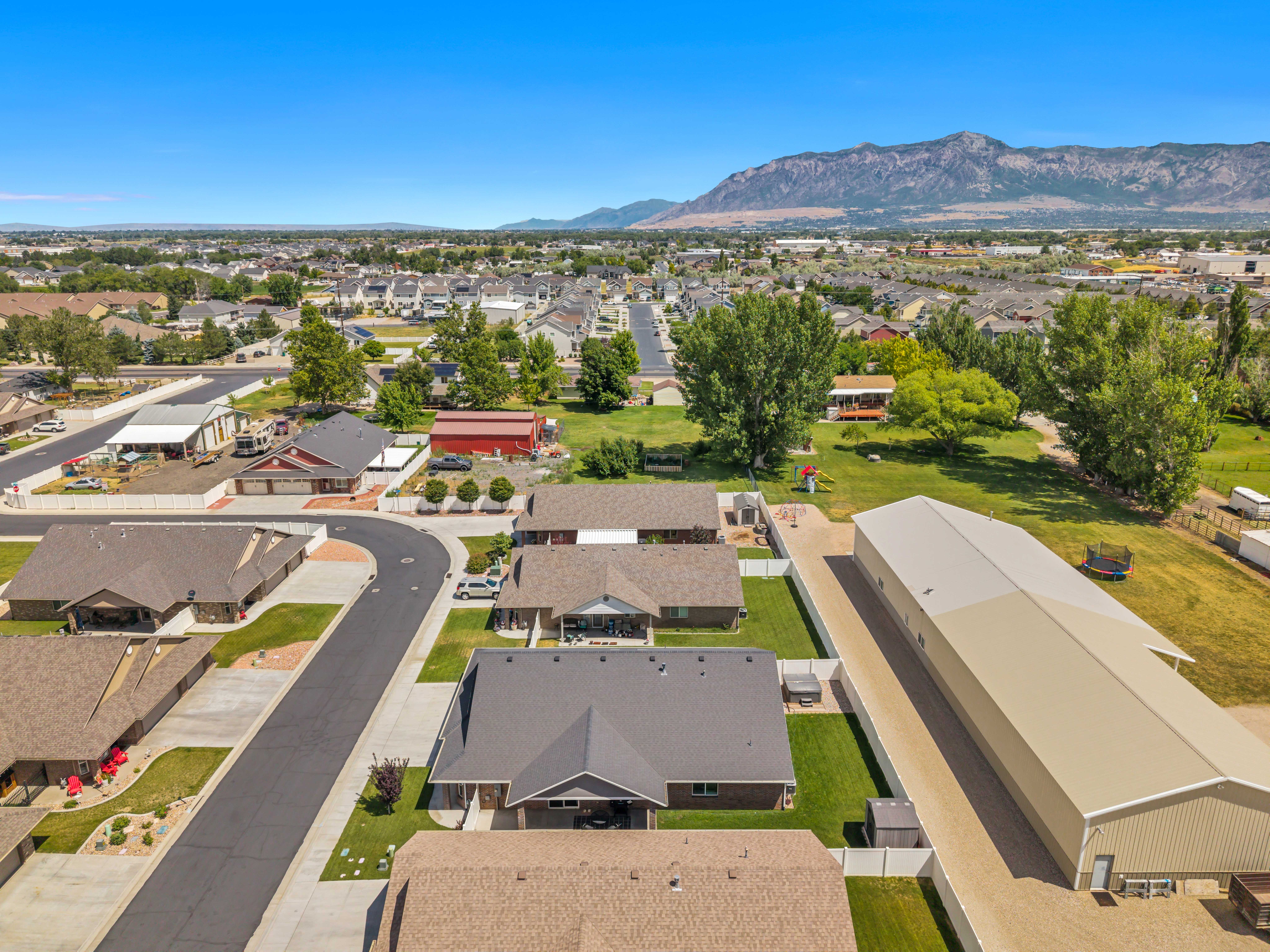 Mountain backdrop framing a residential area with varied rooflines and a large industrial-style building