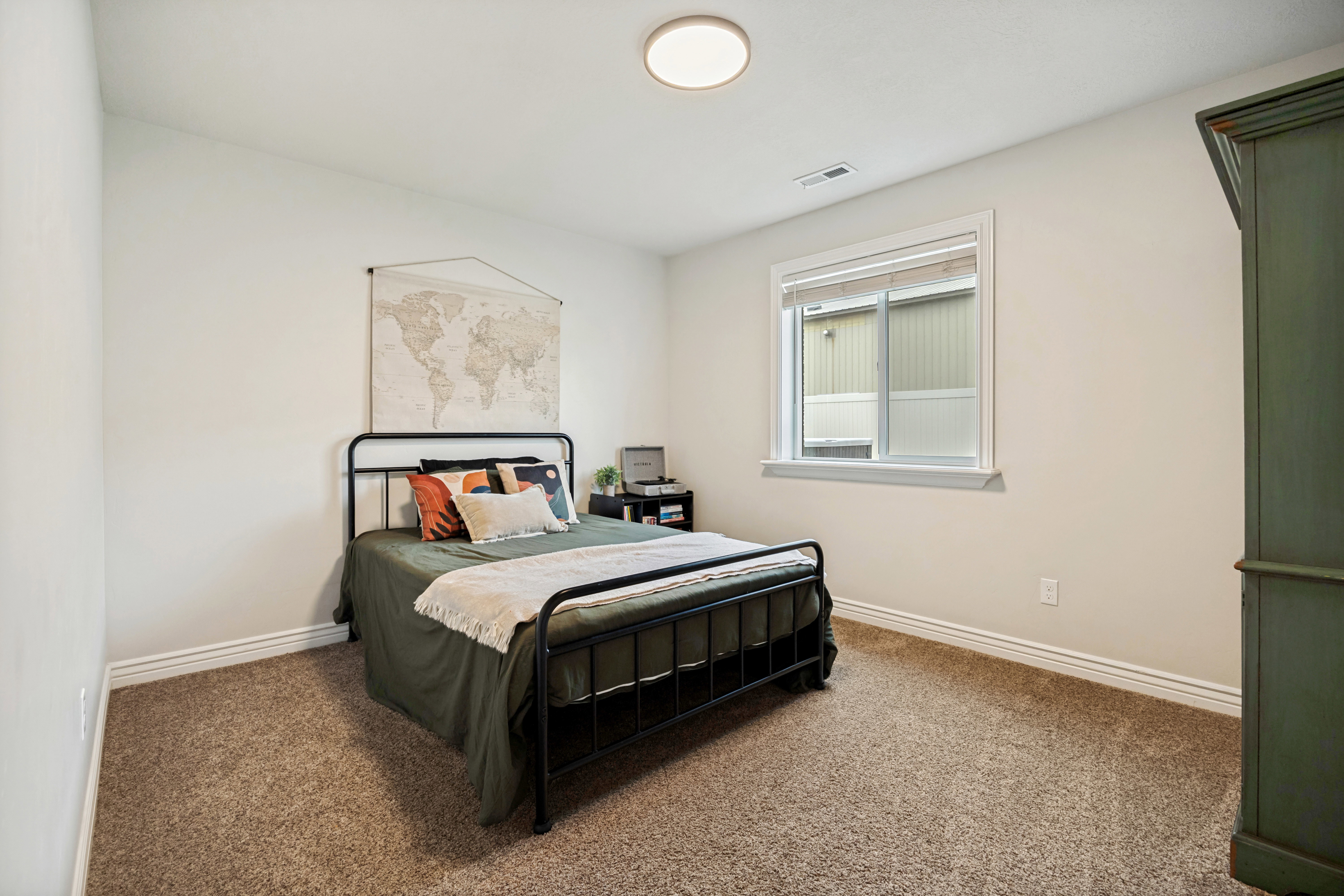 Bedroom featuring neutral wall paint, white trim, and brown carpet flooring