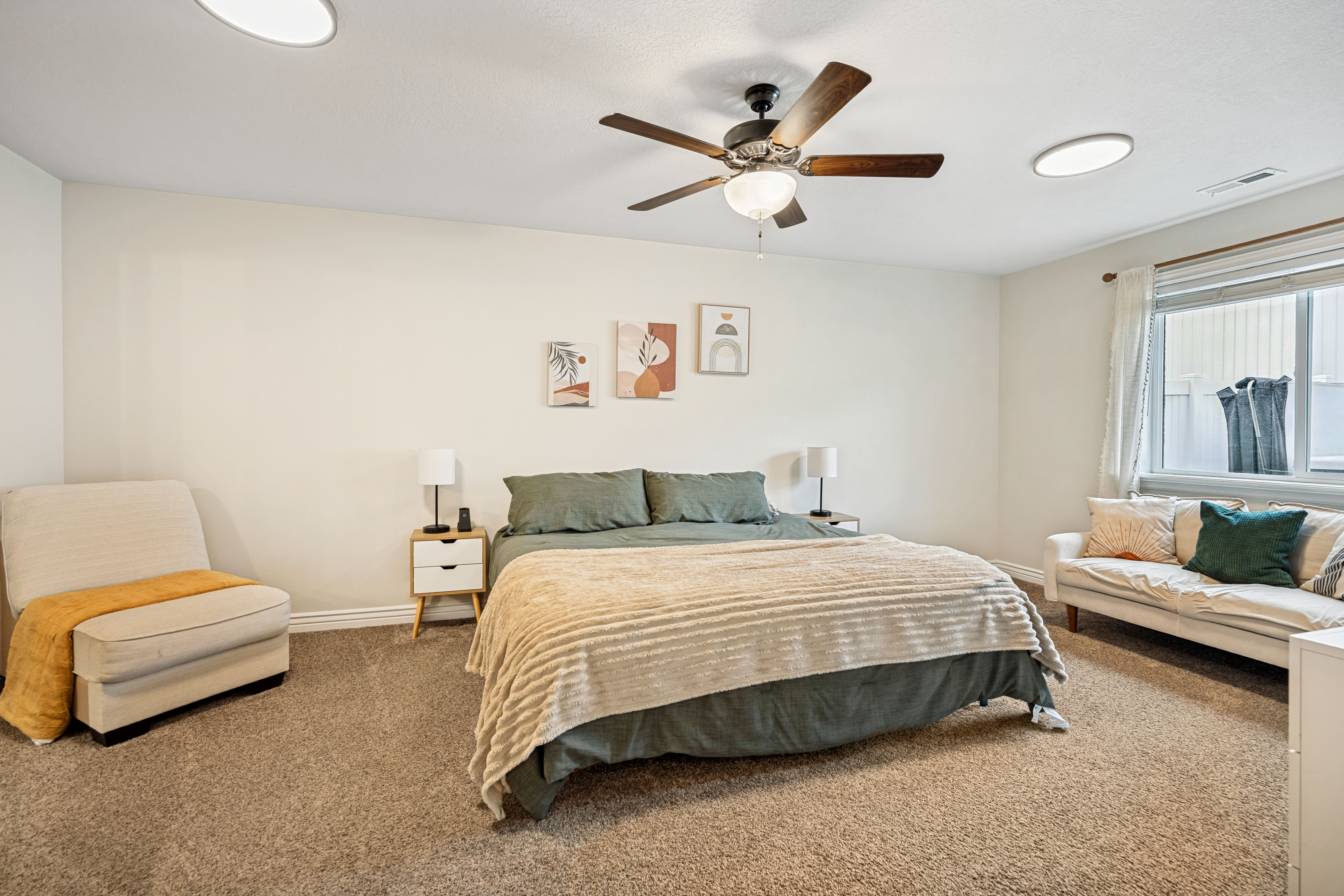 Spacious room featuring neutral carpet flooring and white walls