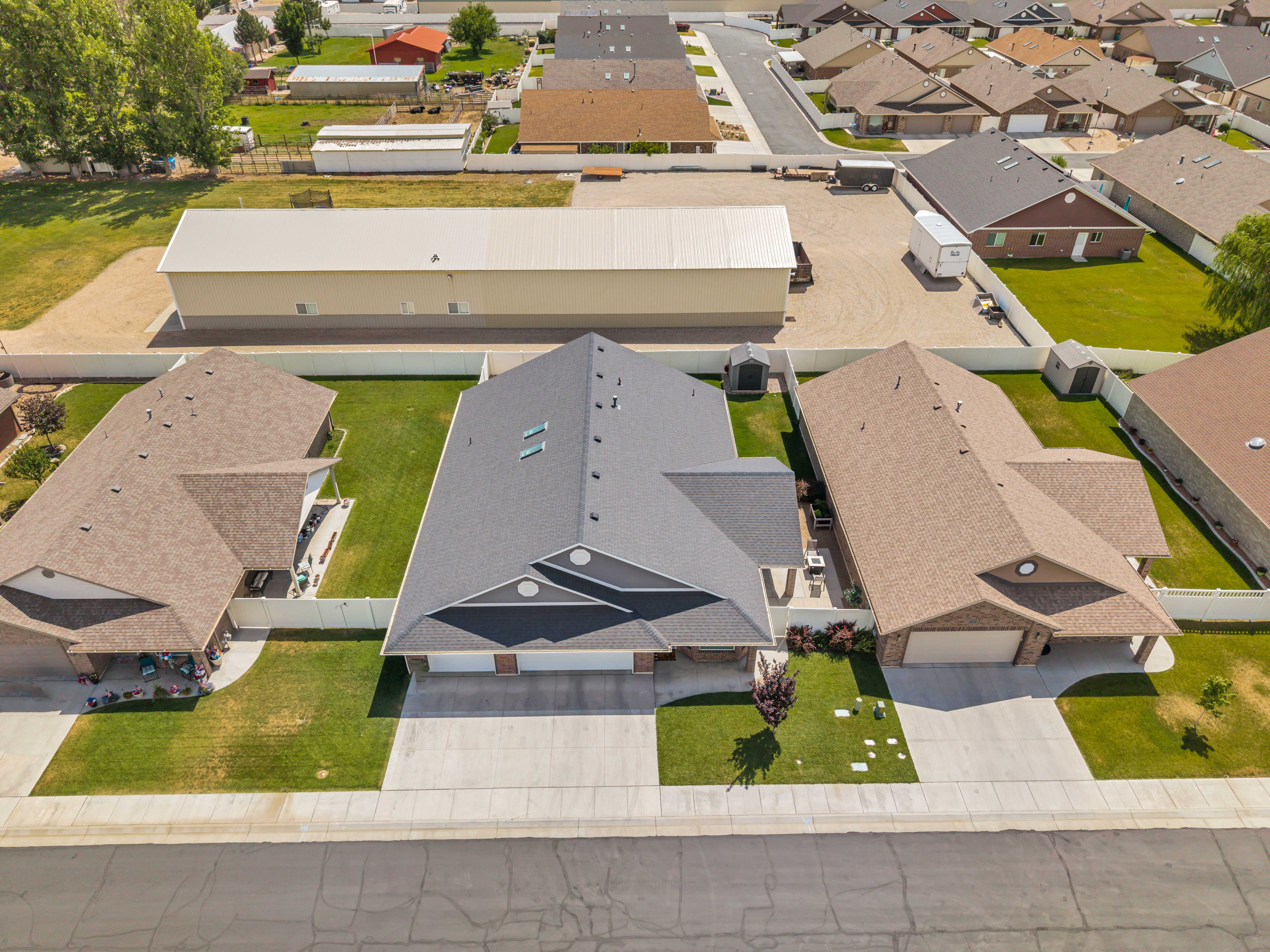 Contemporary residence featuring a dark gray asphalt shingle roof and a two-car garage