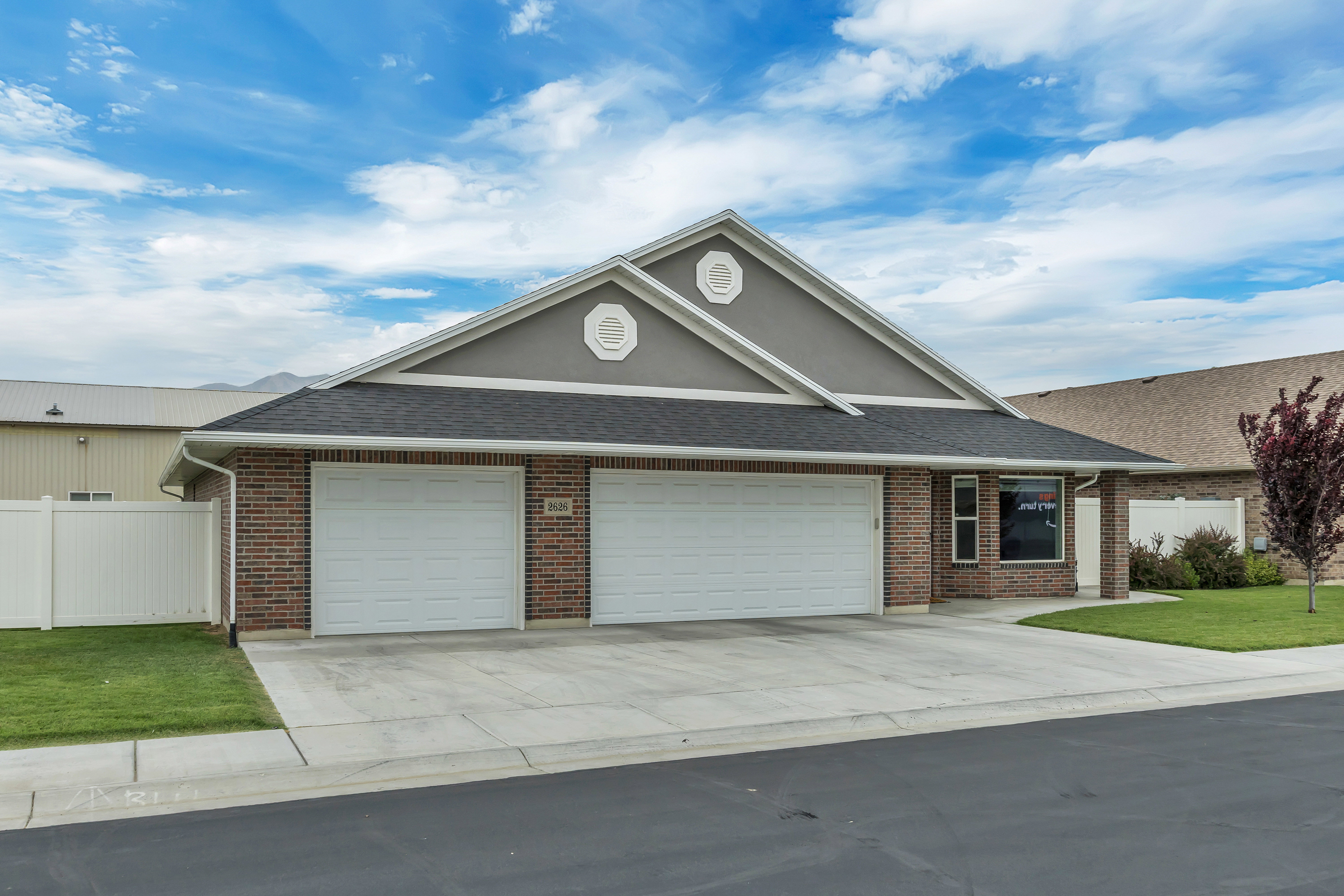 Ranch-style exterior with brick siding and gray stucco accents