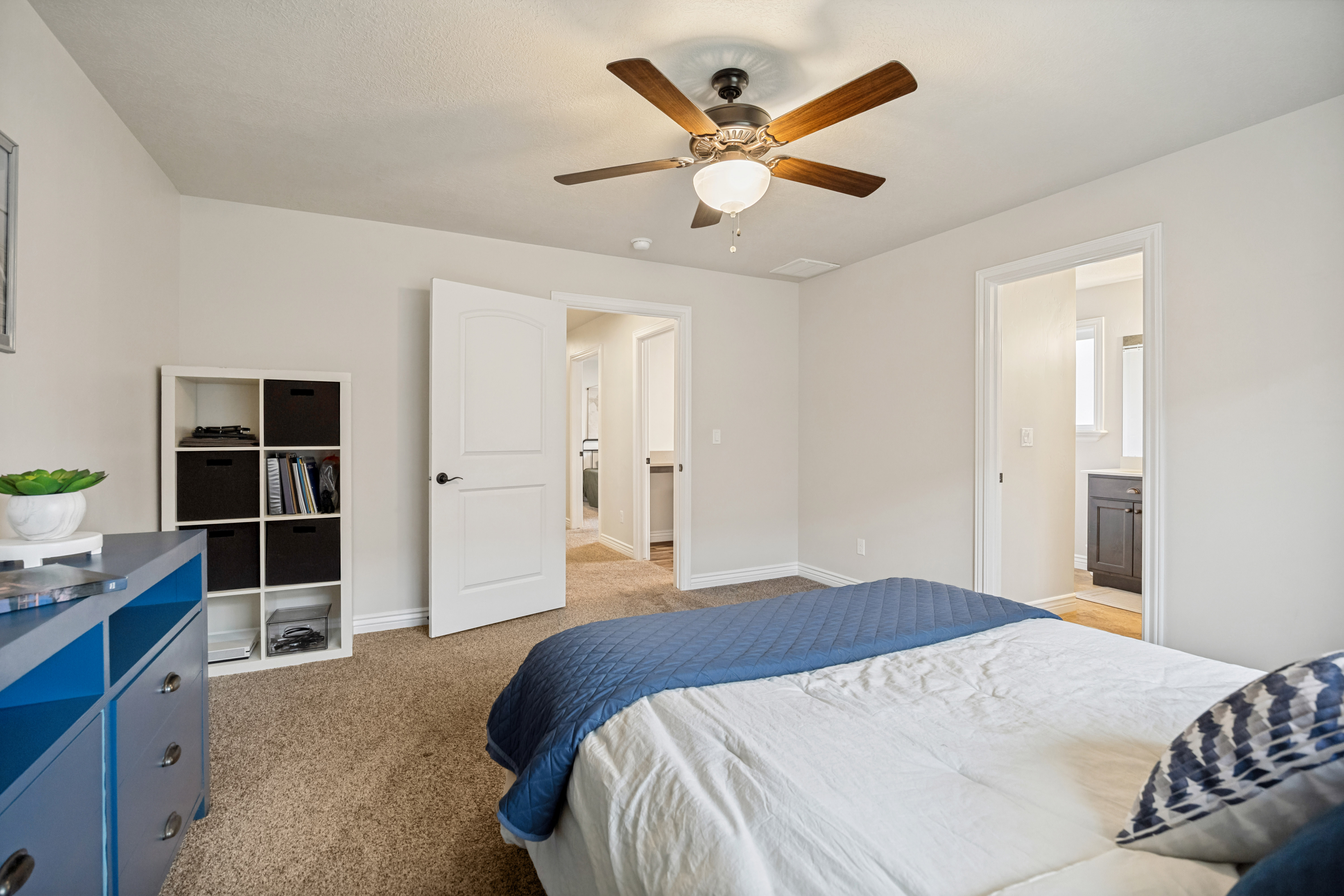 Light-colored walls with textured carpeting throughout the room