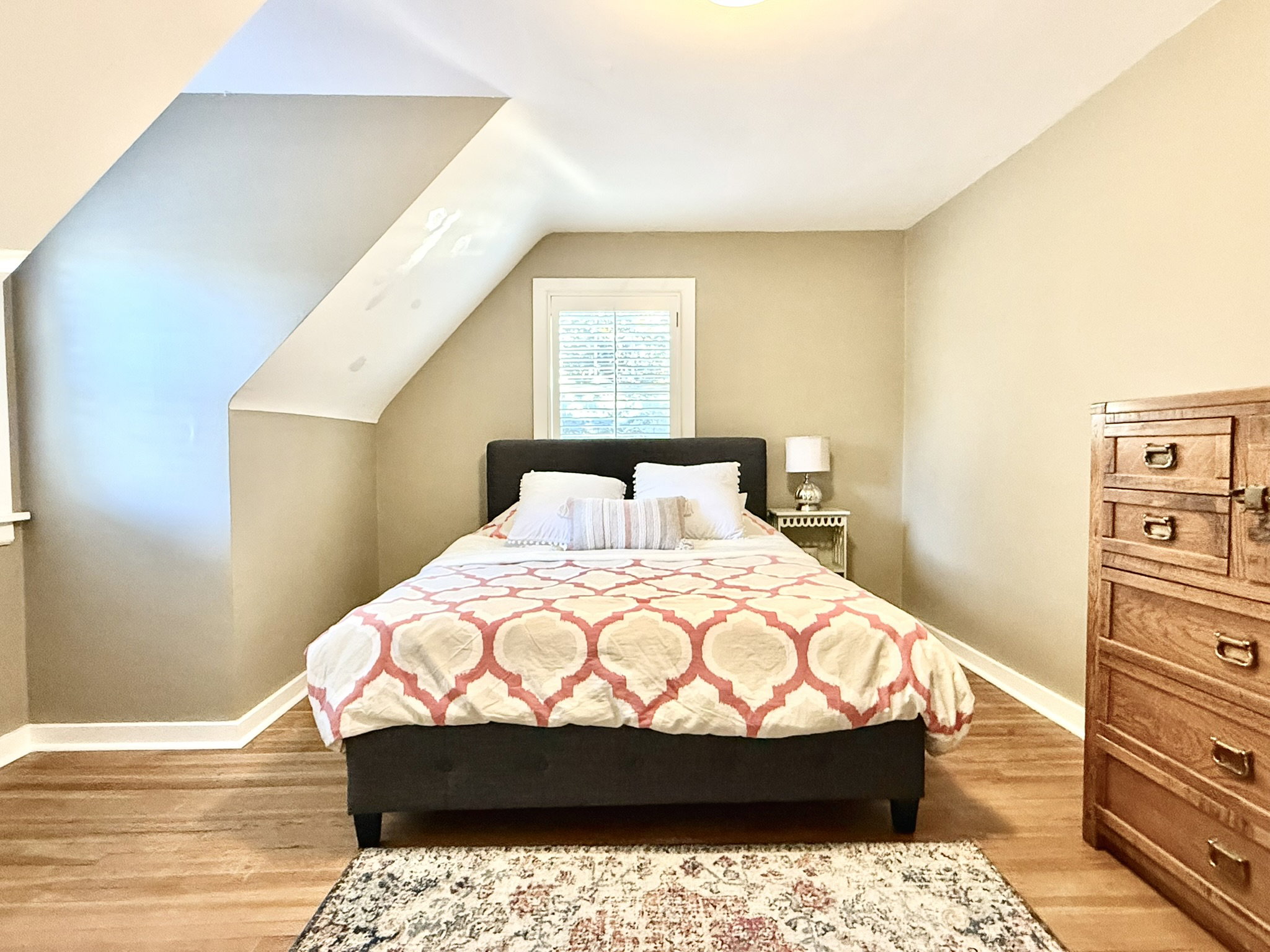 Bedroom #2  featuring sloped ceilings, a window with horizontal blinds, wood-finish flooring, and light-toned wall paint