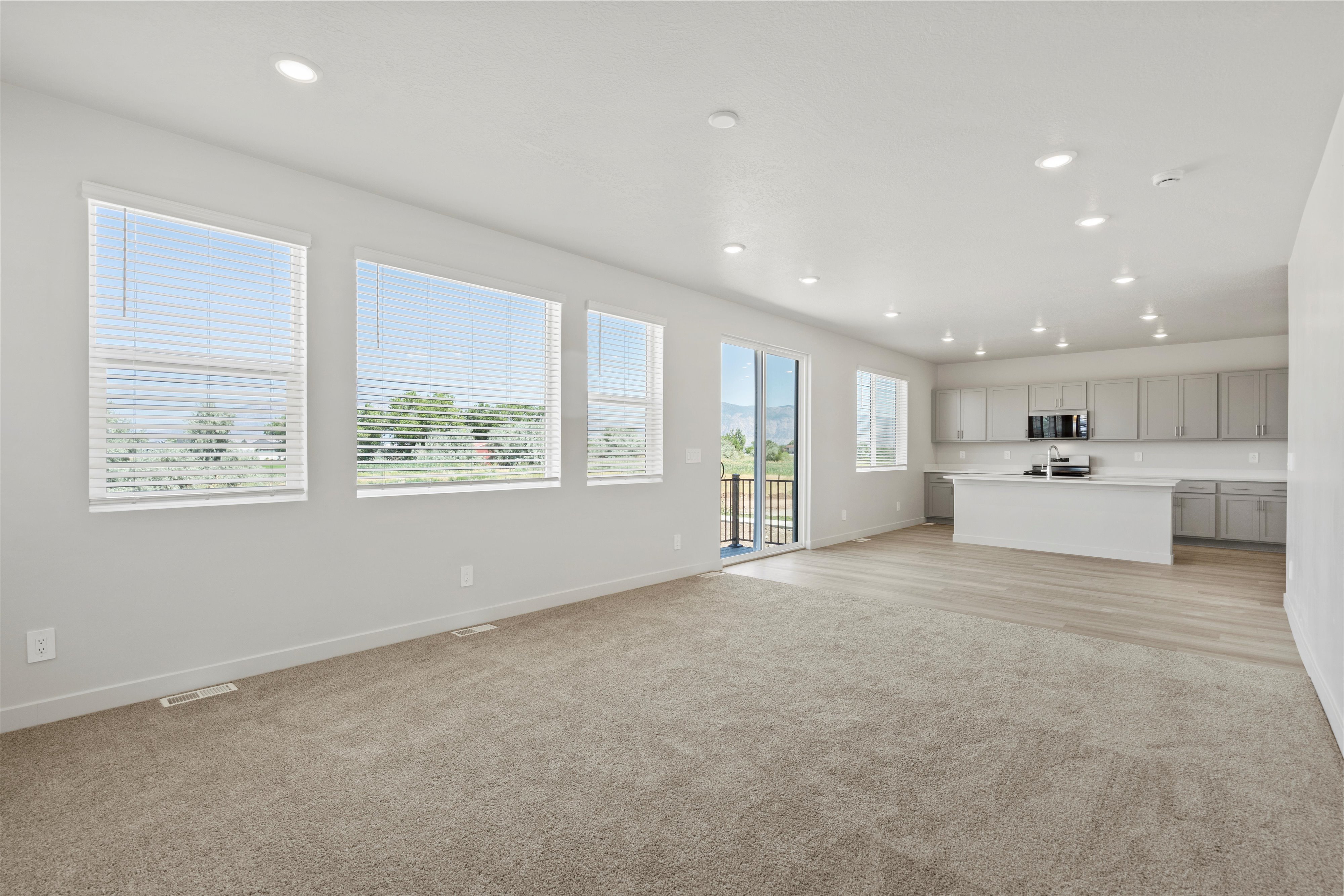 **DISCLAIMER** Interior package may vary. Open-concept interior featuring light gray walls and recessed lighting
