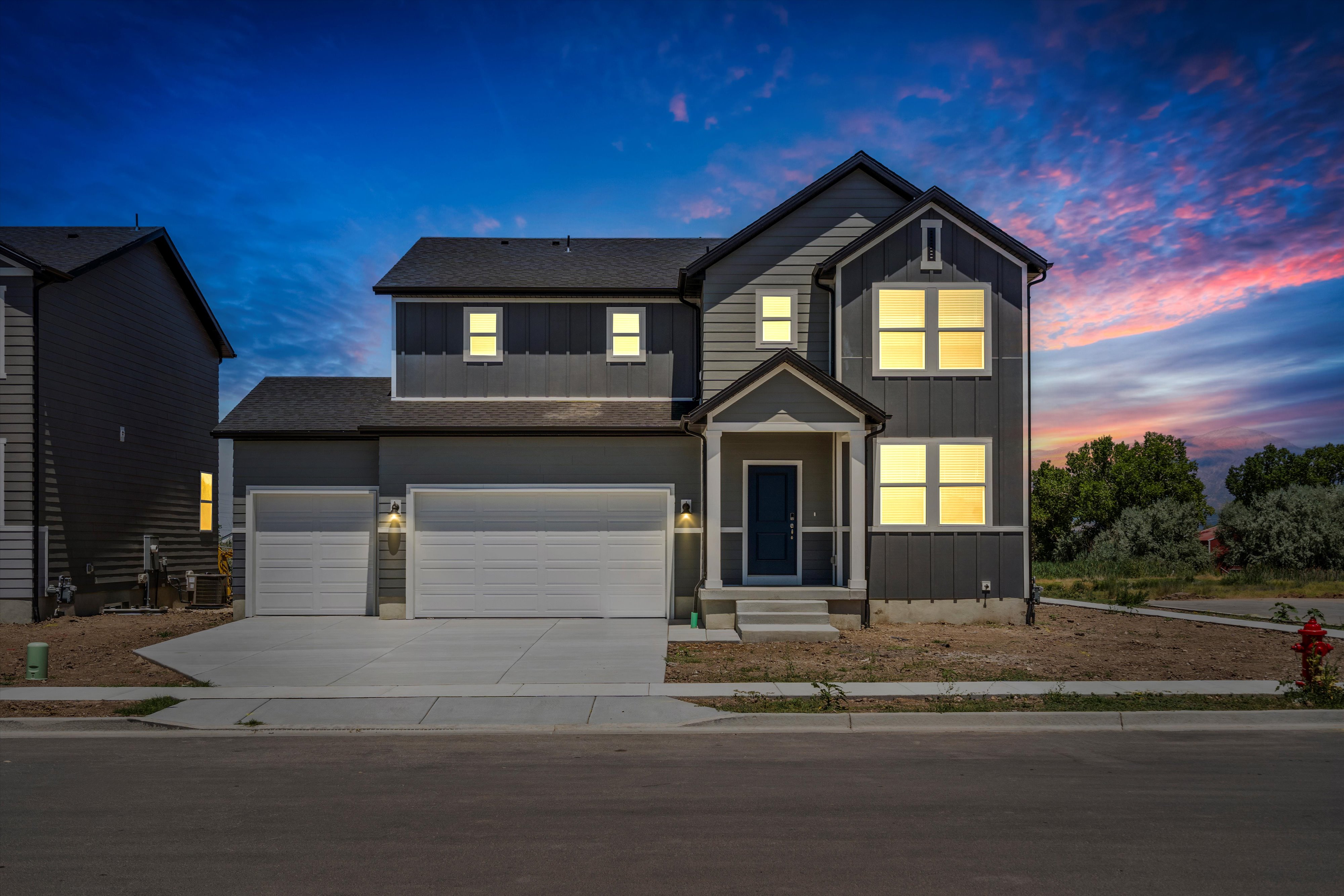 Modern two-story residence with a multi-textured facade, featuring board-and-batten and horizontal siding