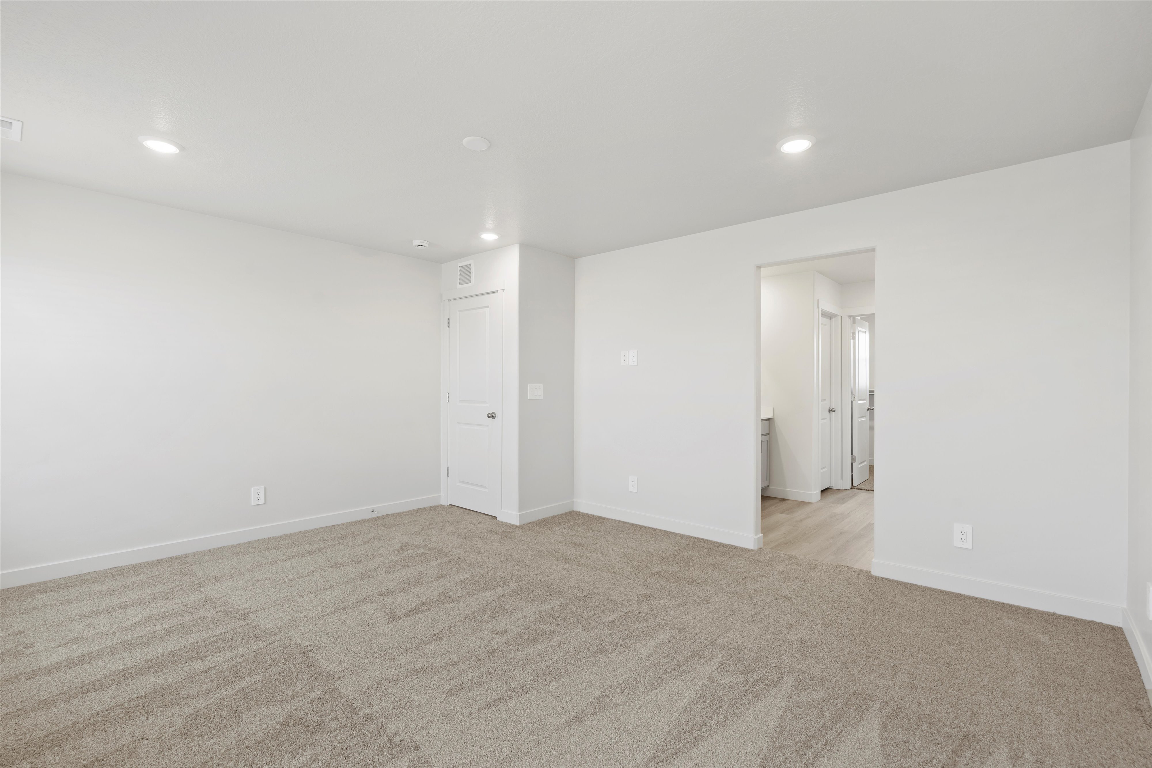 **DISCLAIMER** Interior package may vary. Spacious room featuring neutral carpeting and white painted walls
