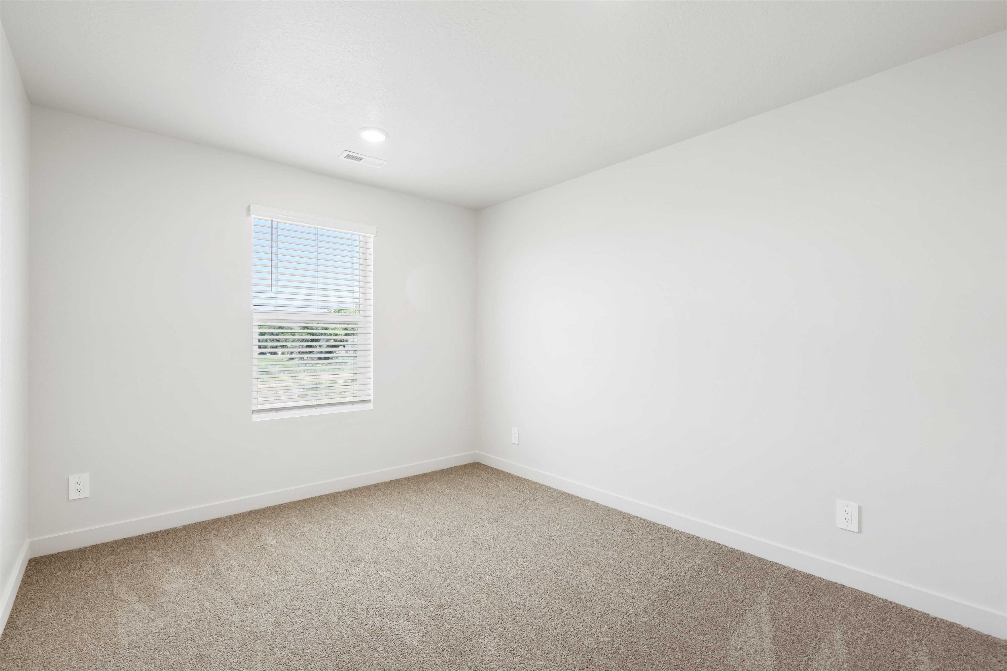 **DISCLAIMER** Interior package may vary. Neutral toned interior featuring light-colored walls, recessed ceiling lighting, and soft carpet flooring