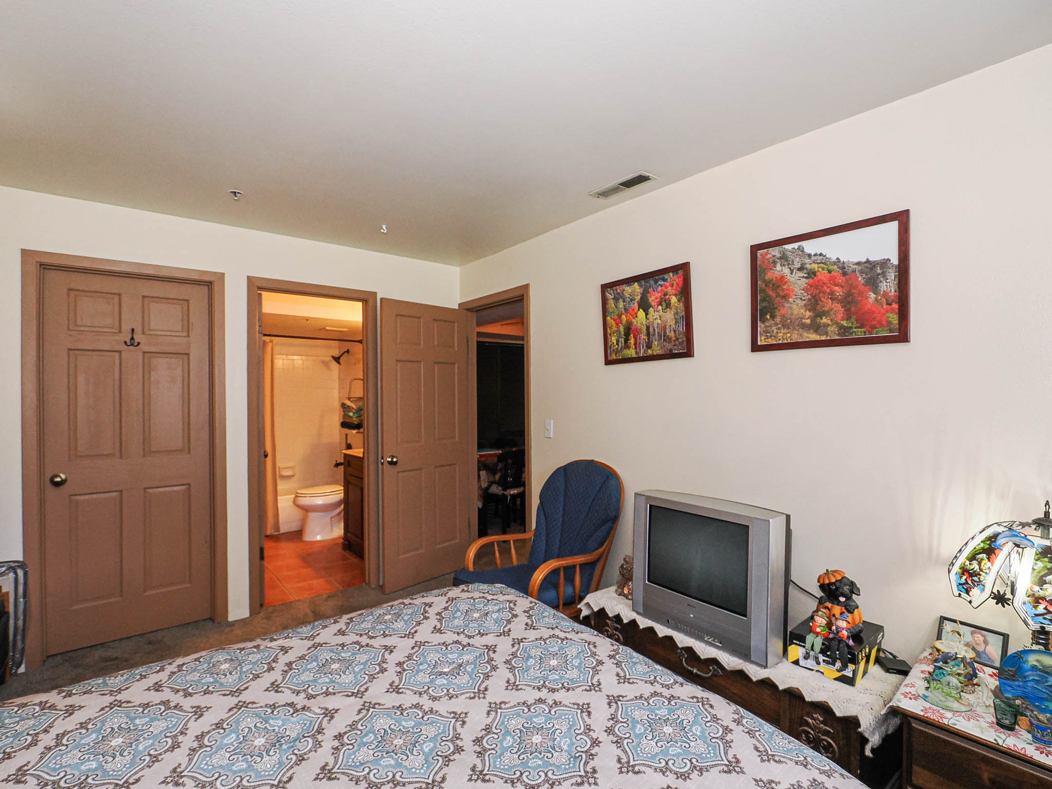 Carpeted room with light-colored walls and brown trim