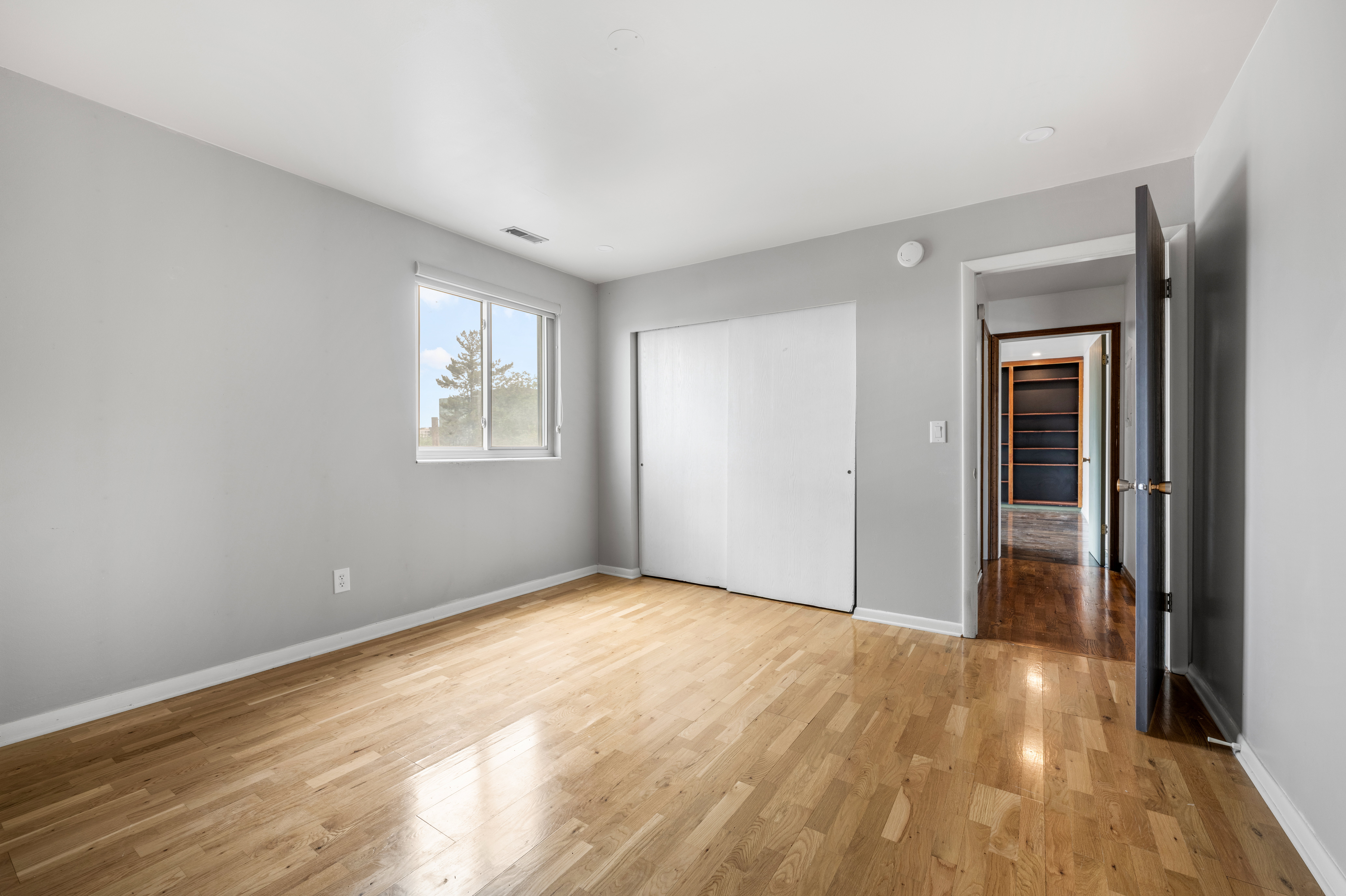 Light wood-finish flooring complements the neutral wall tones