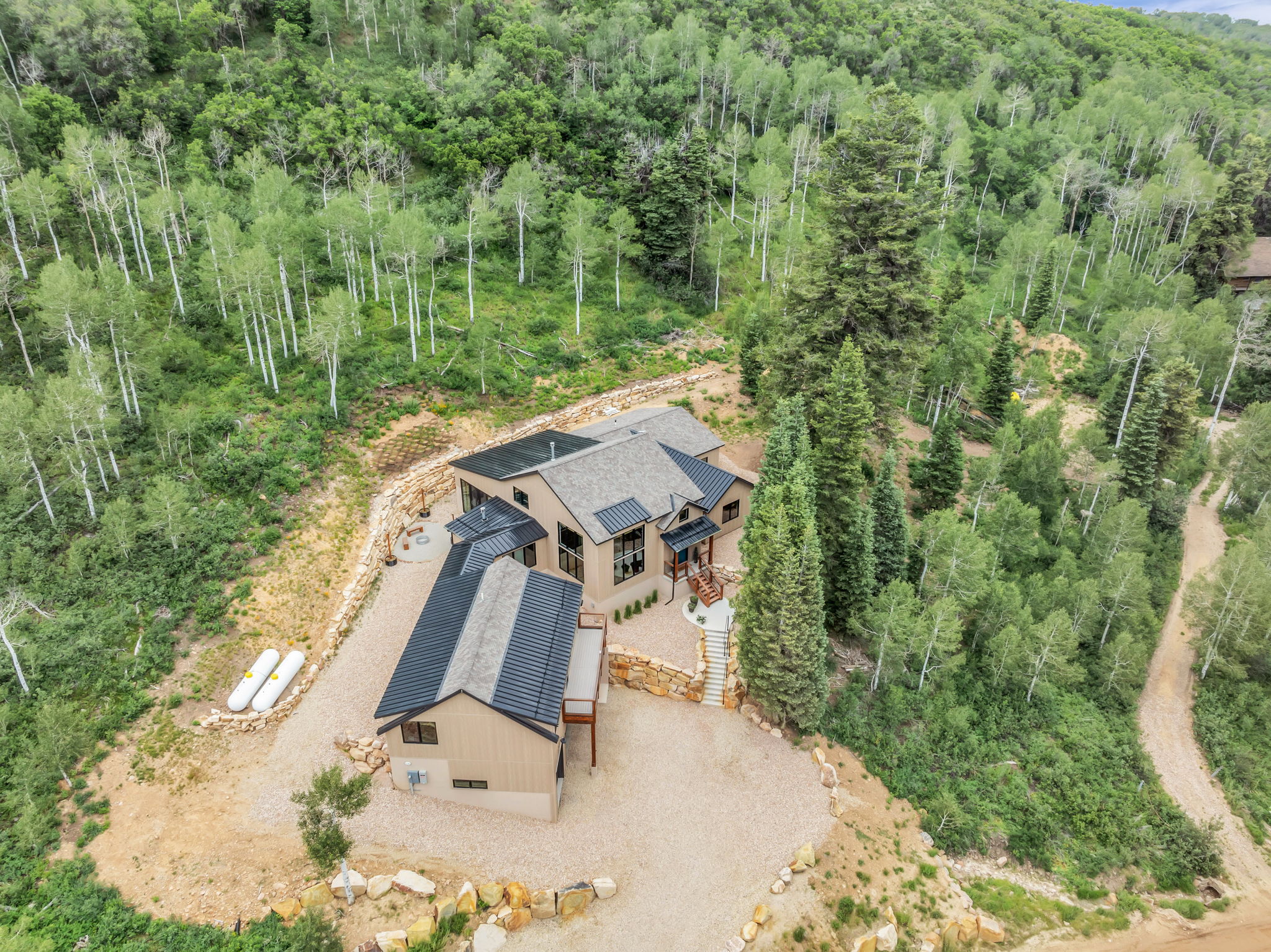 Contemporary mountain residence featuring a multi-level design and a detached structure