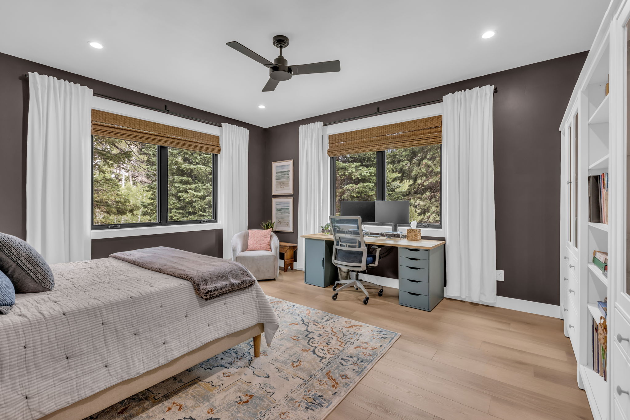 Spacious room featuring multiple windows with natural light, recessed lighting, a ceiling fan, and wood-finish flooring