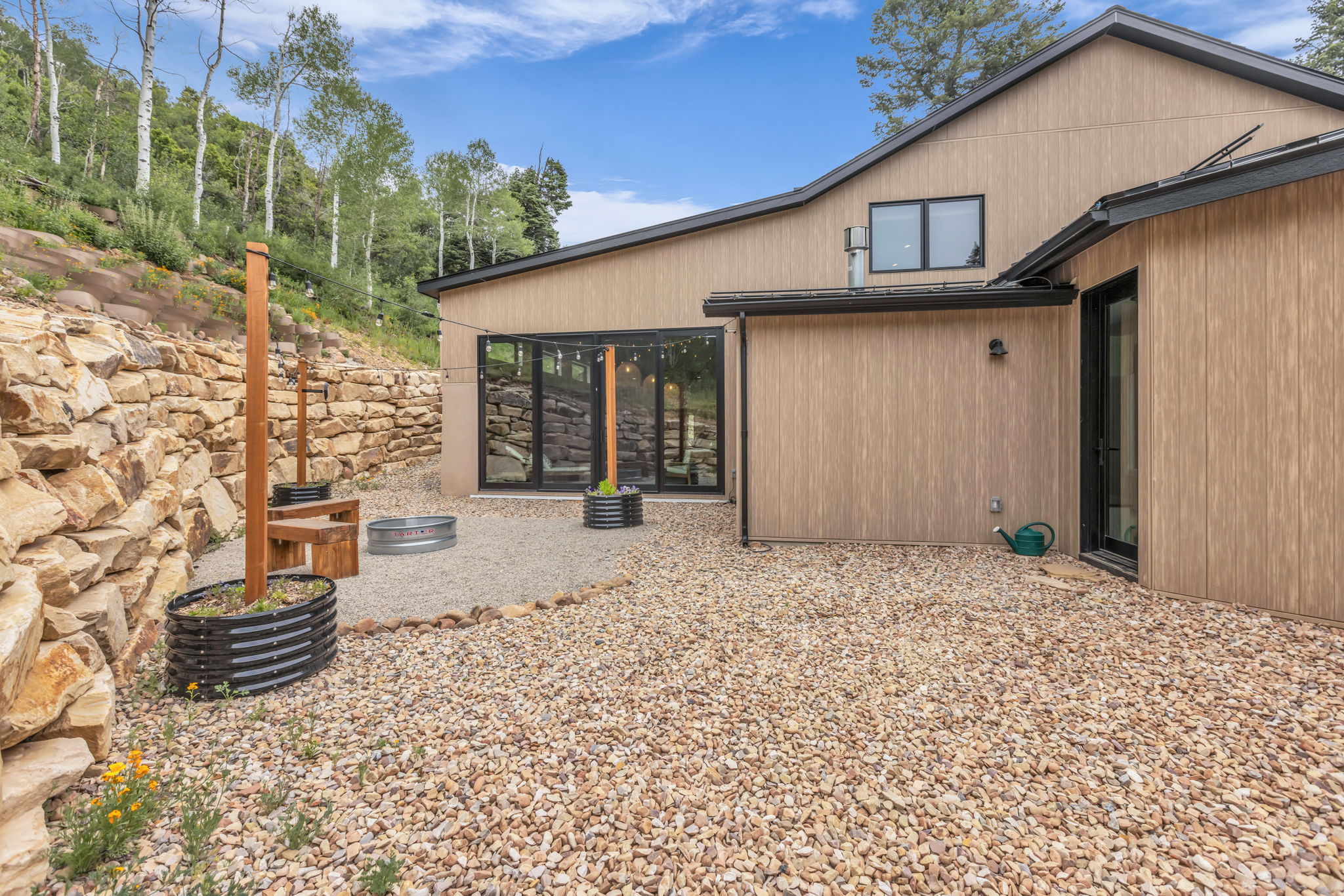 Outdoor gravel patio featuring a built-in fire pit area