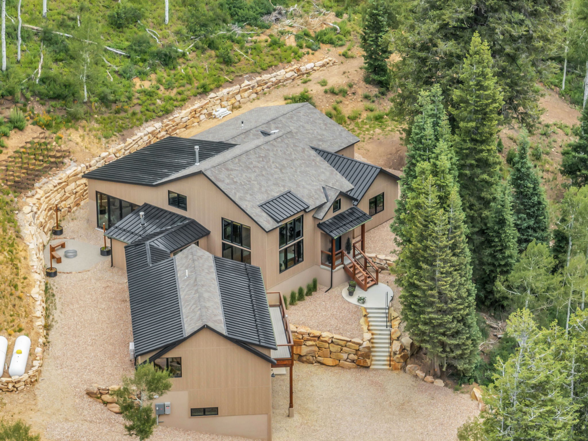 Modern-style residence featuring a combination of light-toned siding and dark metal roofing