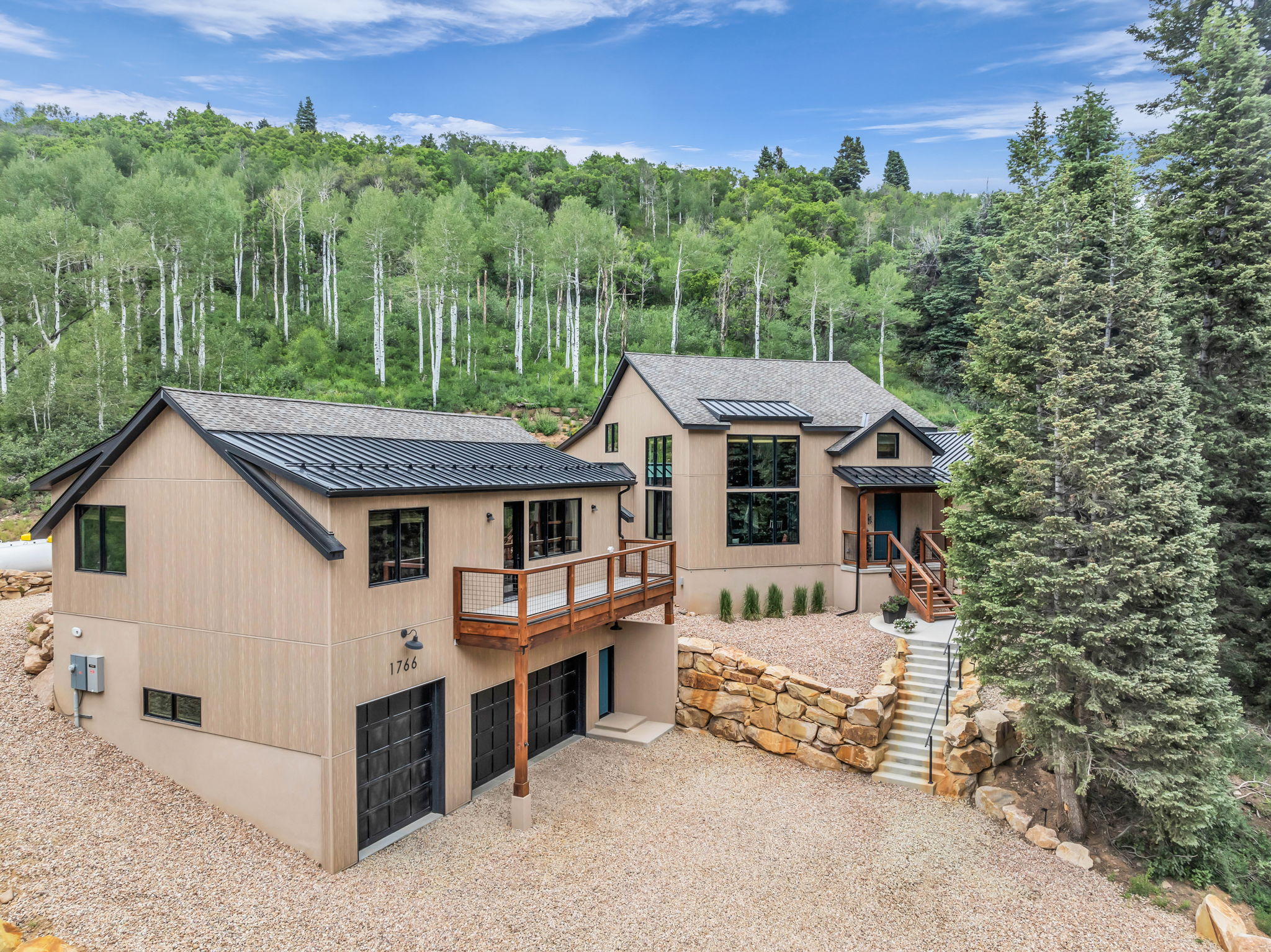 Contemporary residence featuring tan siding and black trim