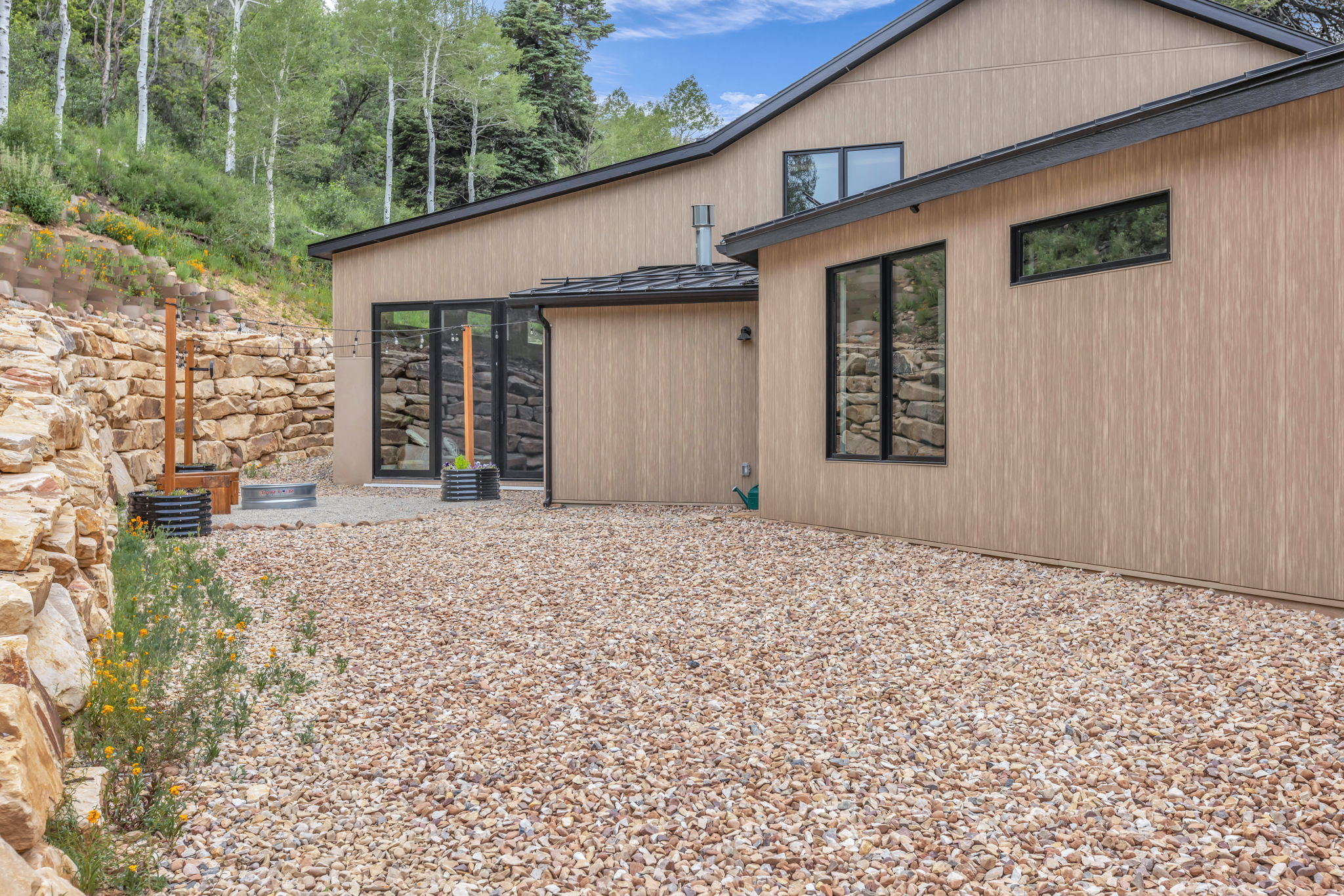 Modern exterior with light wood-finish siding and dark trim