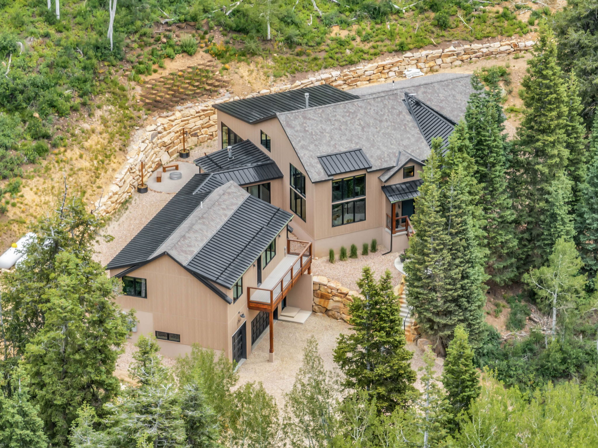 Modern residence featuring a neutral-toned exterior and dark trim