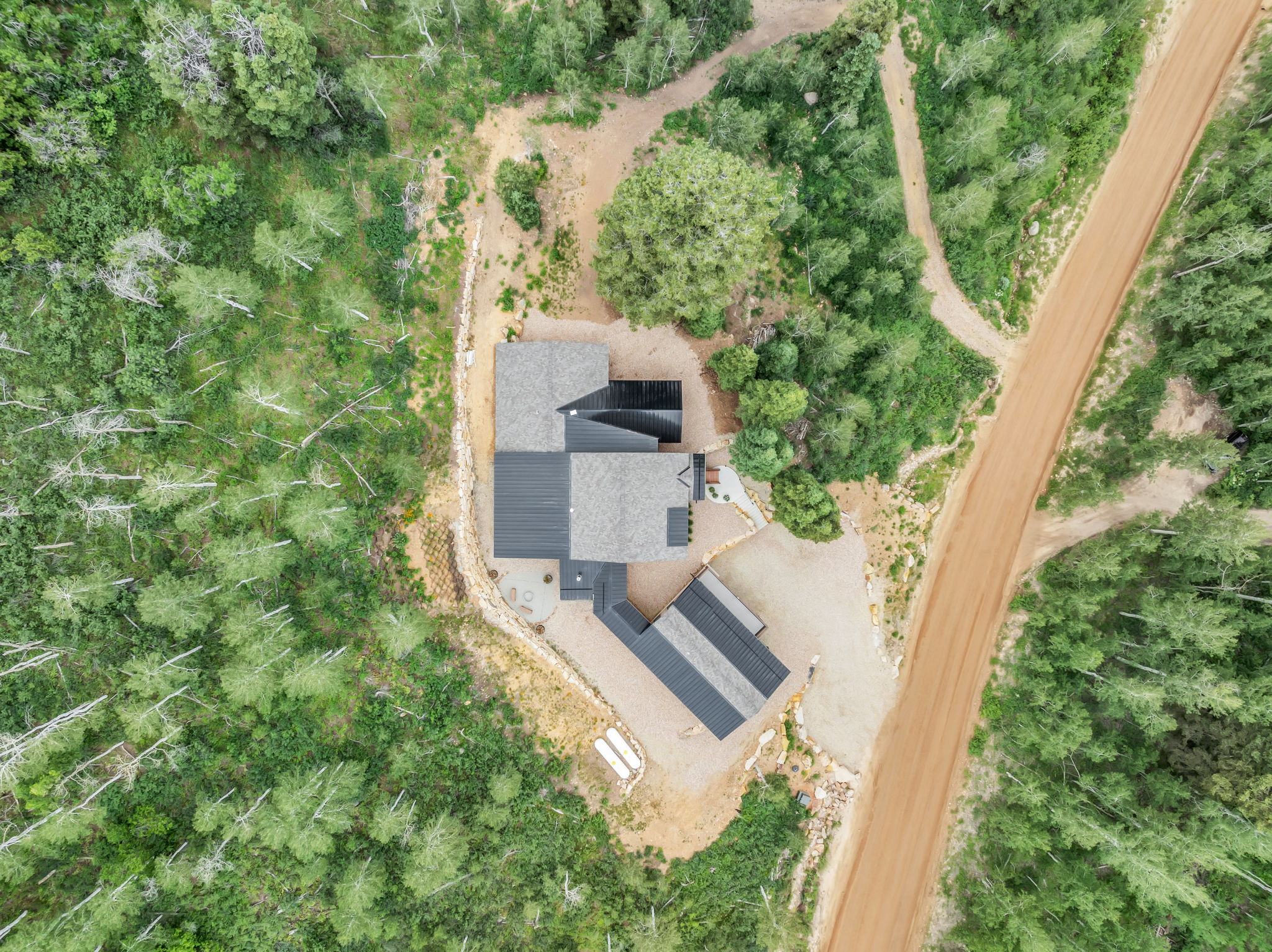 Aerial perspective showcasing a contemporary residence with a detached structure