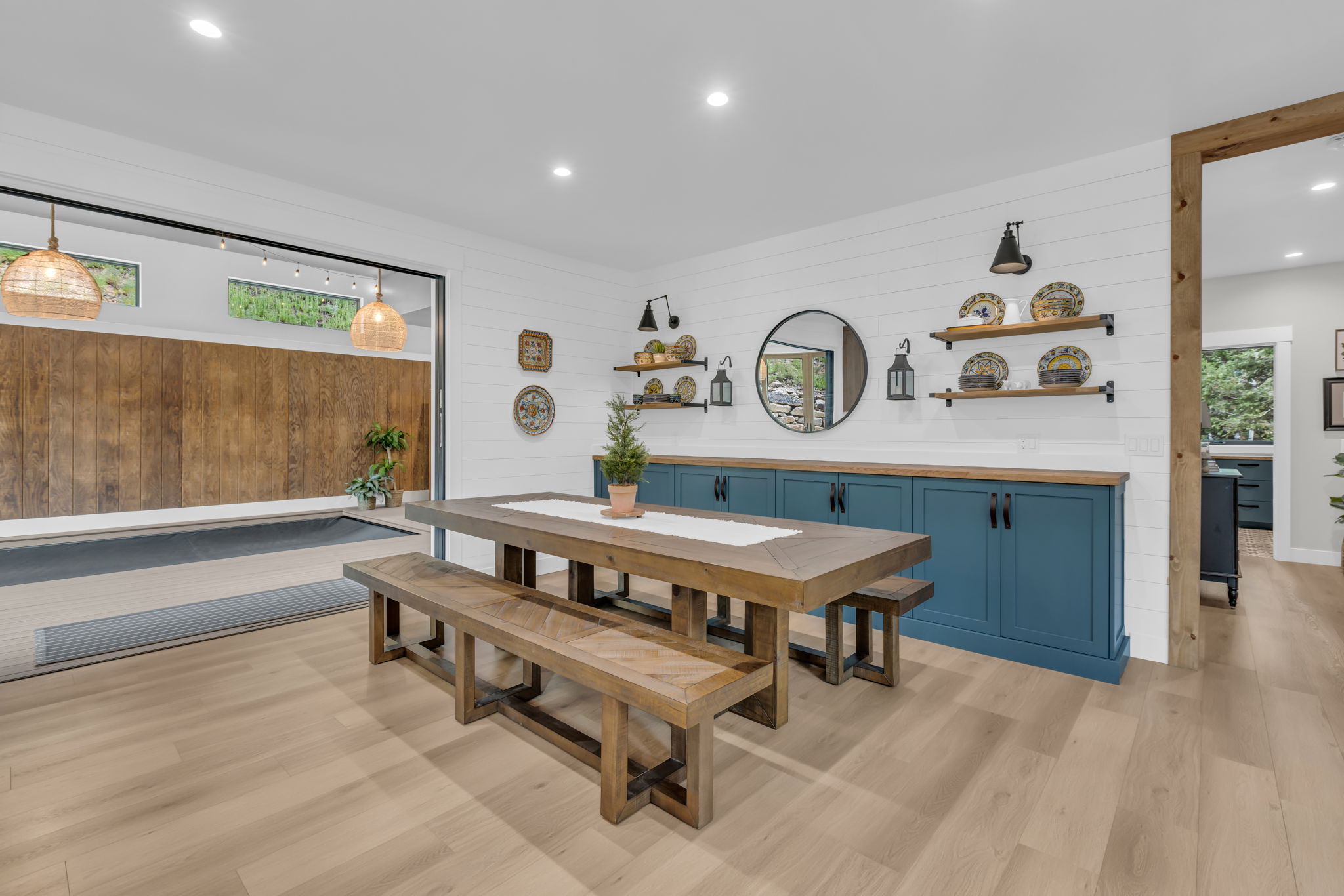 Spacious dining area featuring wood-finish flooring, shiplap wall finishes, and recessed lighting