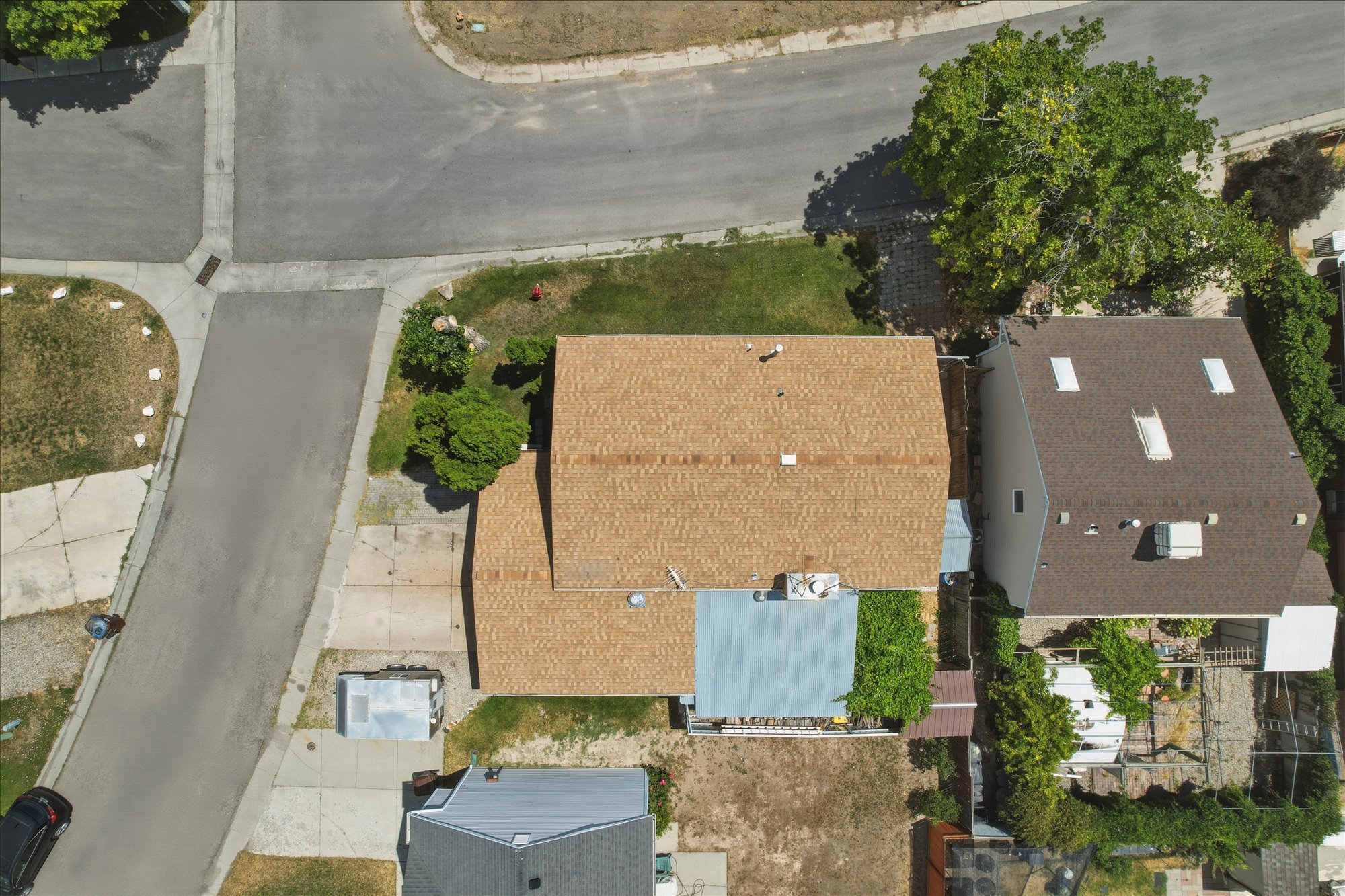 Brown shingle roof with skylights and an attached patio cover