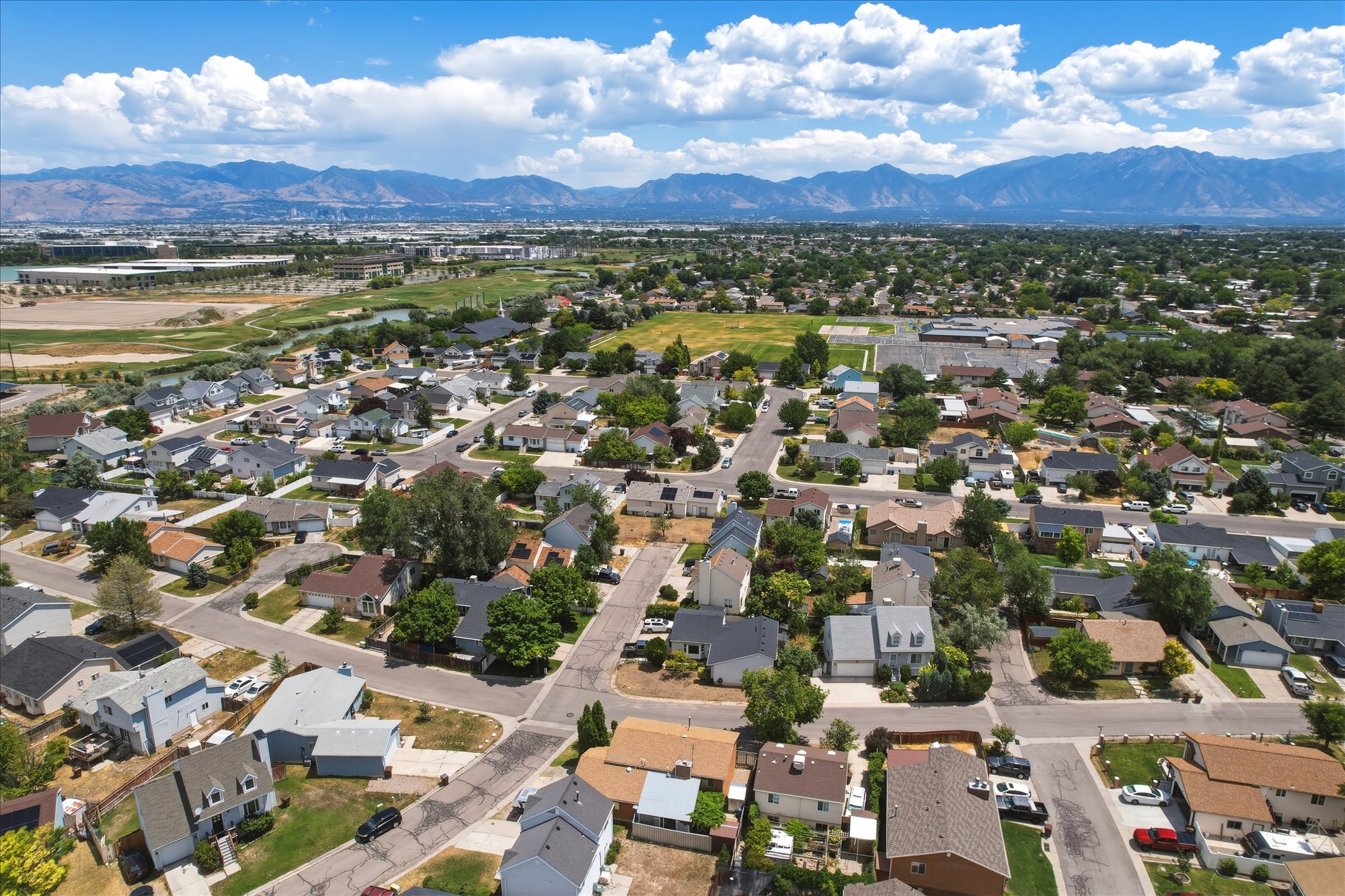 Expansive neighborhood with diverse residential architecture and mature landscaping