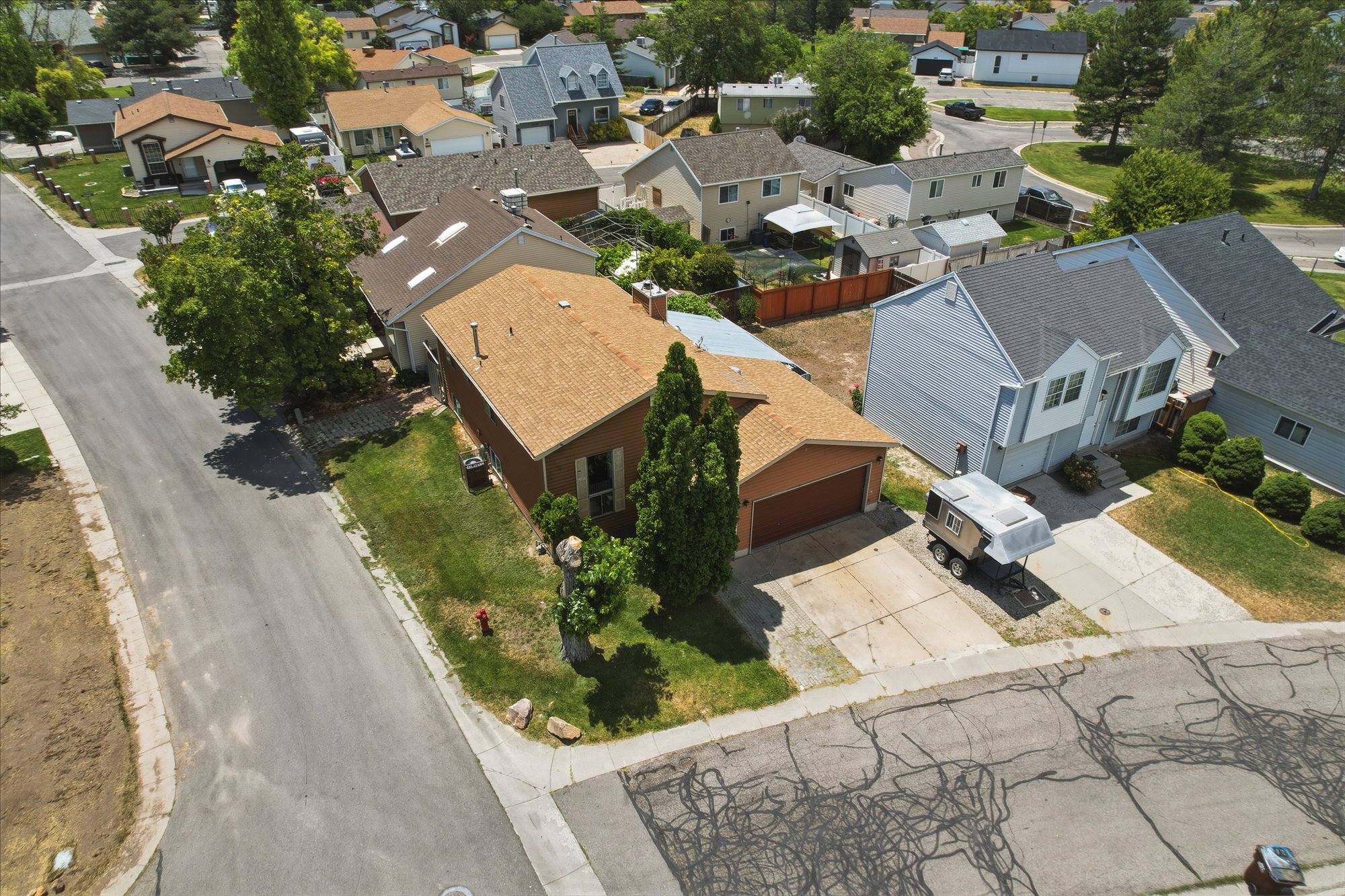 Two-story residential property featuring a light blue exterior, a gabled roof, and a concrete driveway