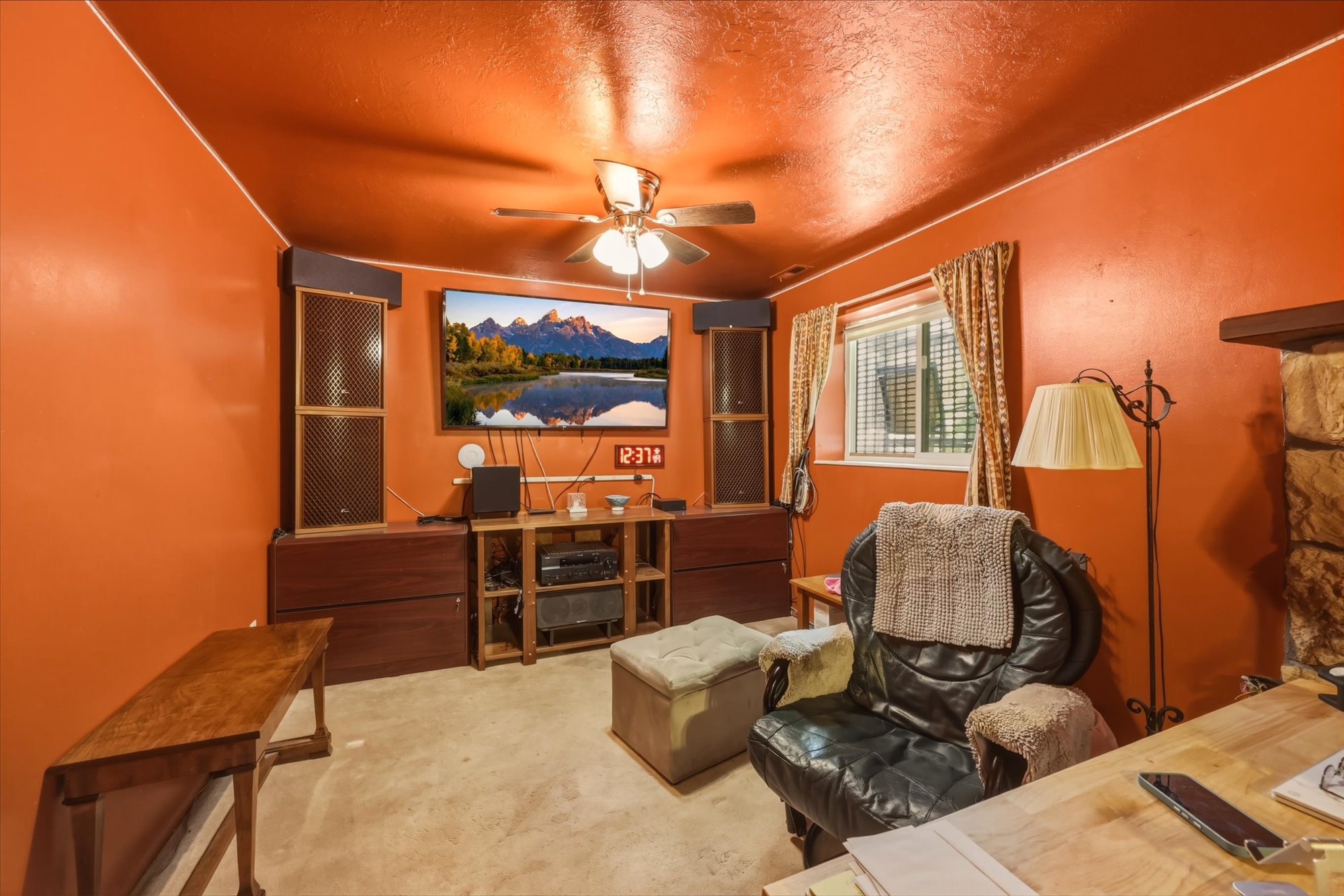 Interior space featuring a window with blinds, a ceiling fan, and carpet flooring