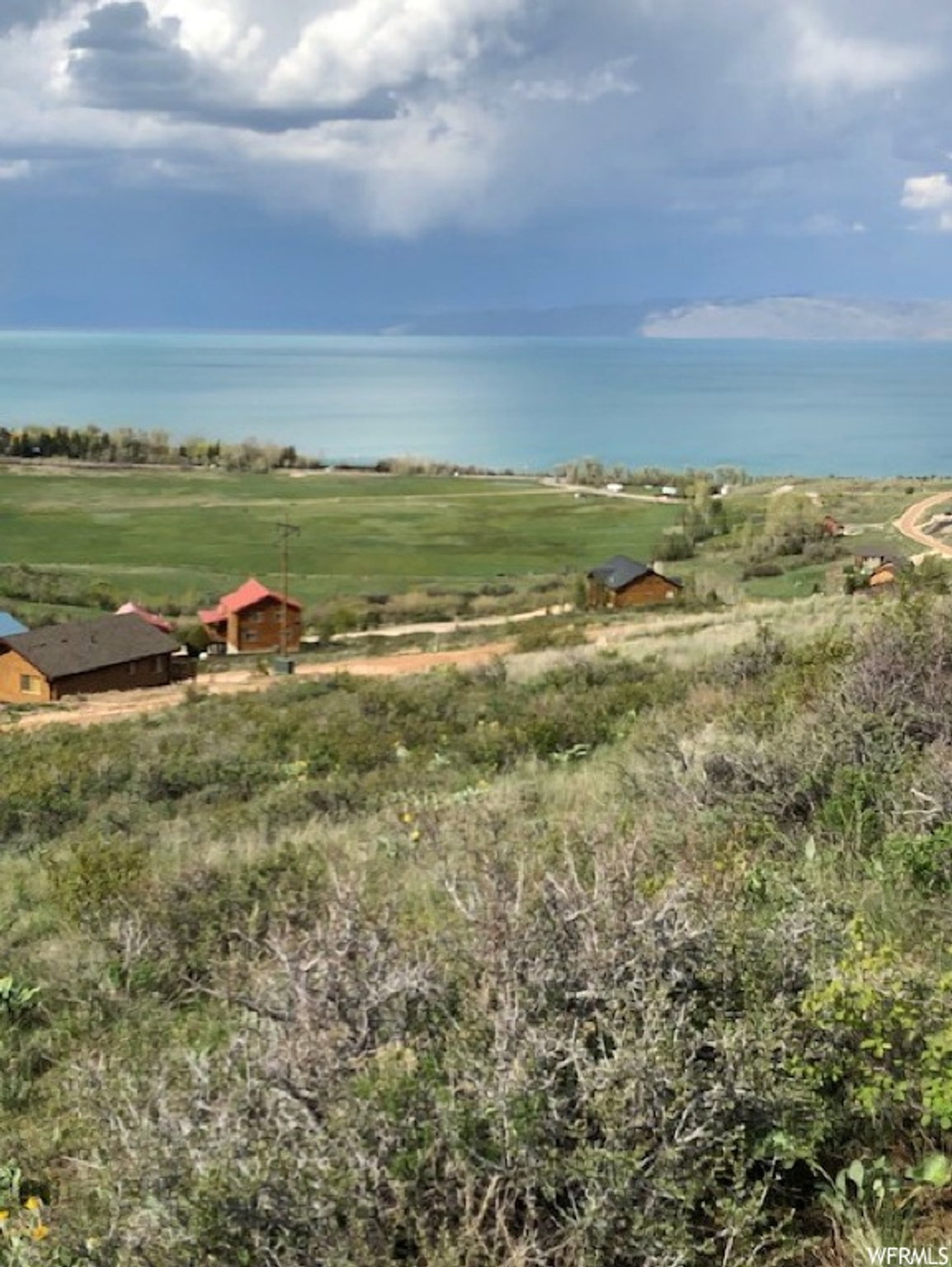 Expansive elevated terrain offering broad water and distant land formations