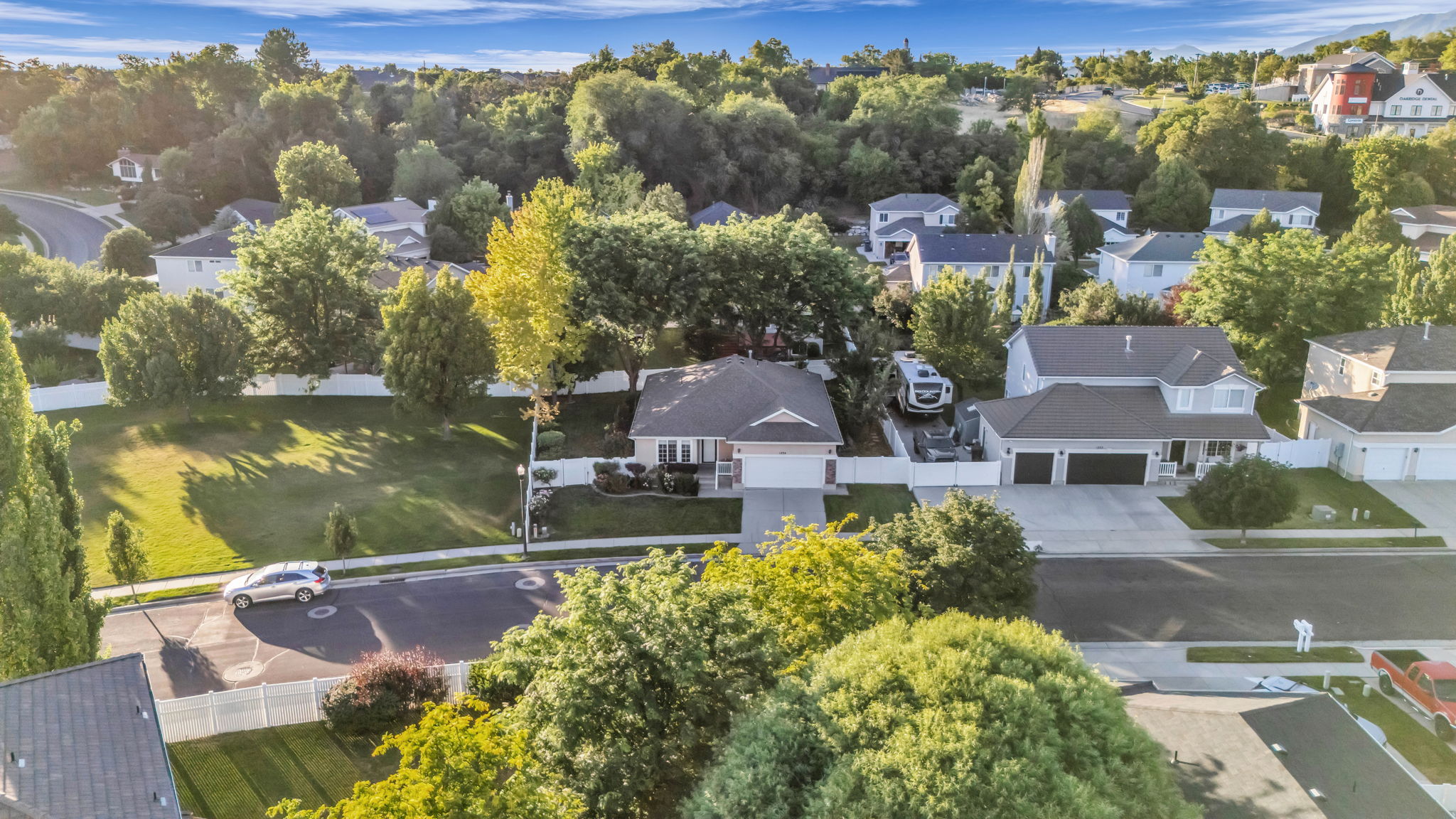 Suburban neighborhood featuring a variety of residential properties, mature trees, and paved streets