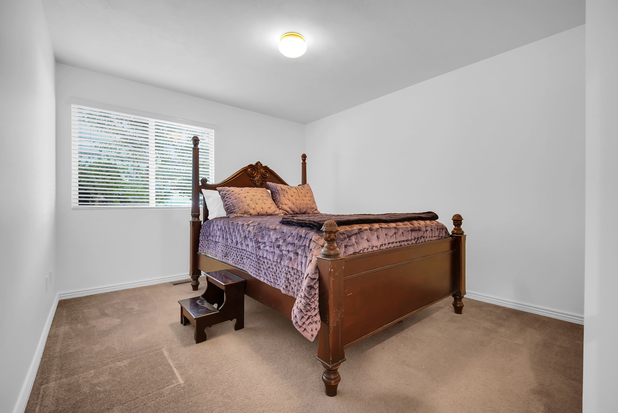 Room with light beige carpet flooring and white baseboards