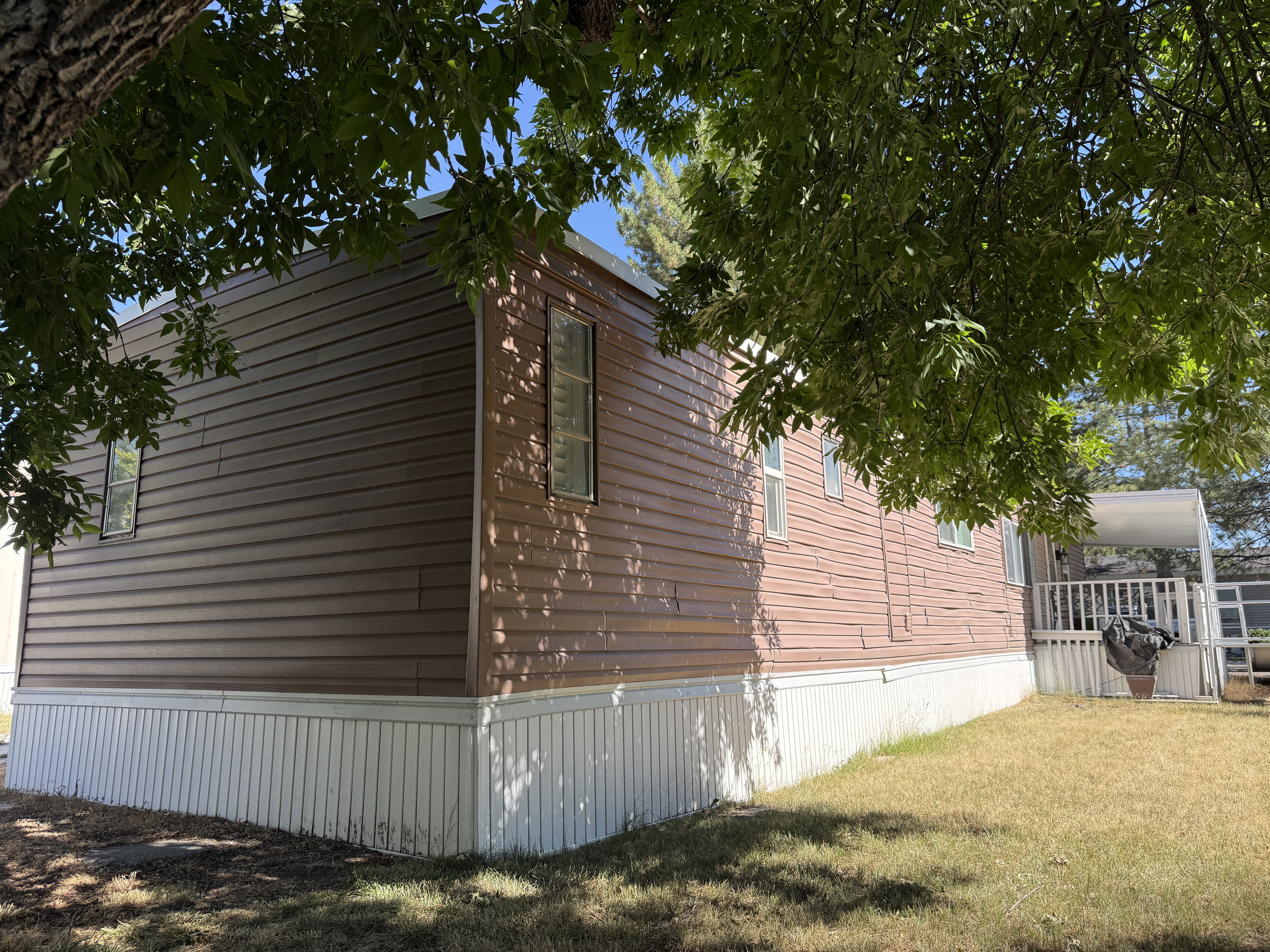 Brown horizontal siding with white skirting