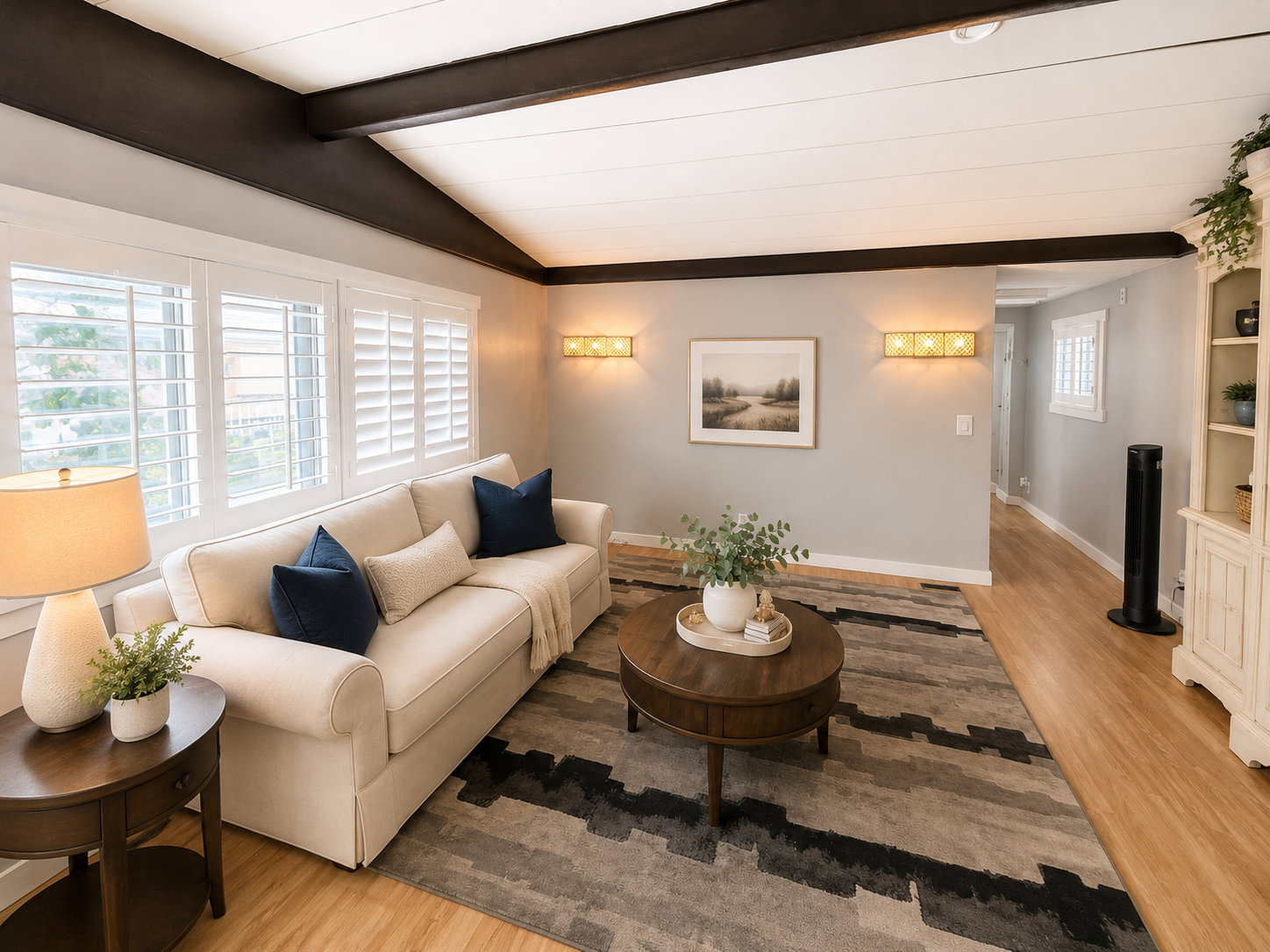 Vaulted ceiling with exposed dark wood beams and light-toned ceiling panels