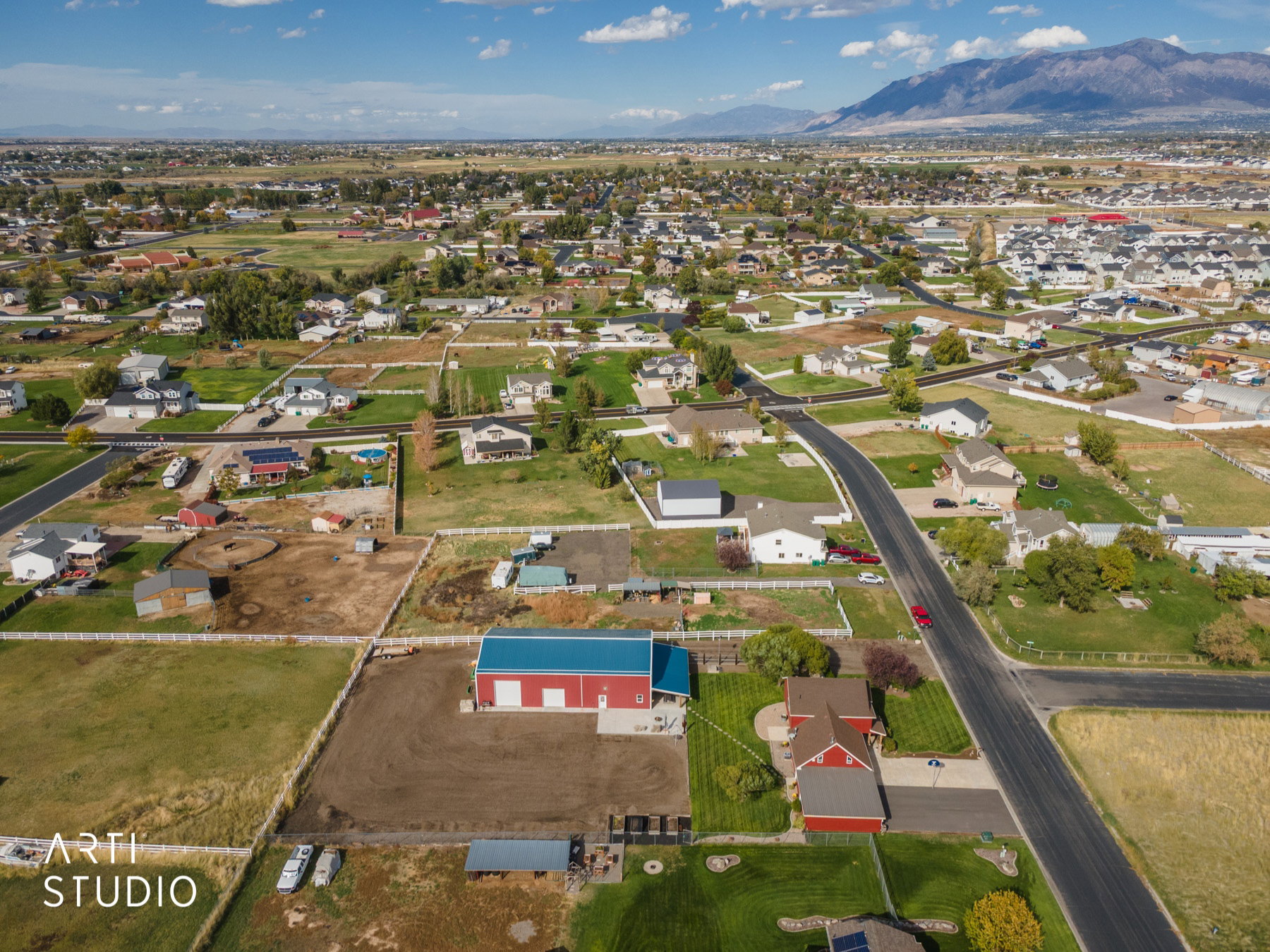 Aerial view showcasing expansive residential properties with a mountainous backdrop